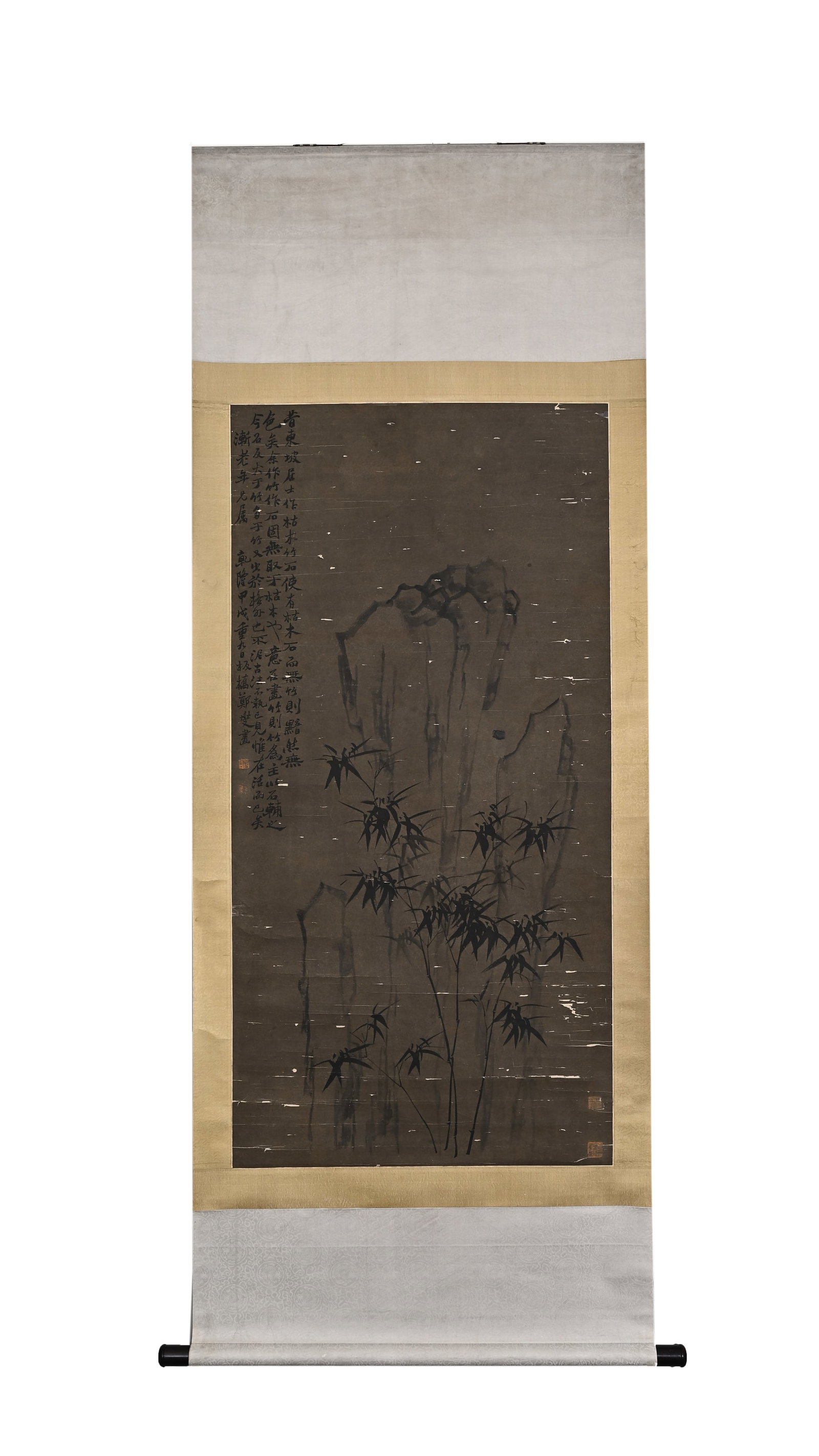 BAMBOO AND STONE SCROLL BY ZHENG BANQIAO OF THE QING DYNASTY (1693-1765): H:137cm(53.94in) W:68cm(26.77in)A vertical ink bamboo painting on paper of the Qing Dynasty, featuring slender bamboo beside lake rocks rendered in light ink, with a lengthy running script inscription
