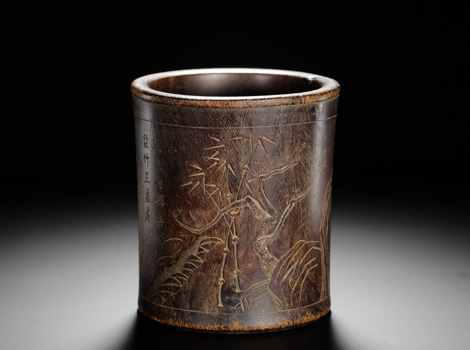QING DYNASTY SANDALWOOD SHALLOWLY ENGRAVED PEN HOLDER OF POEMS AND ESSAYS BY THE THREE FRIENDS OF: H:14cm (5.51in) D:12.5cm (4.92in) Weight:530g (1.17lb)Solid zitan wood cylindrical brush pot incised with pine,bamboo,plum and calligraphic inscription.