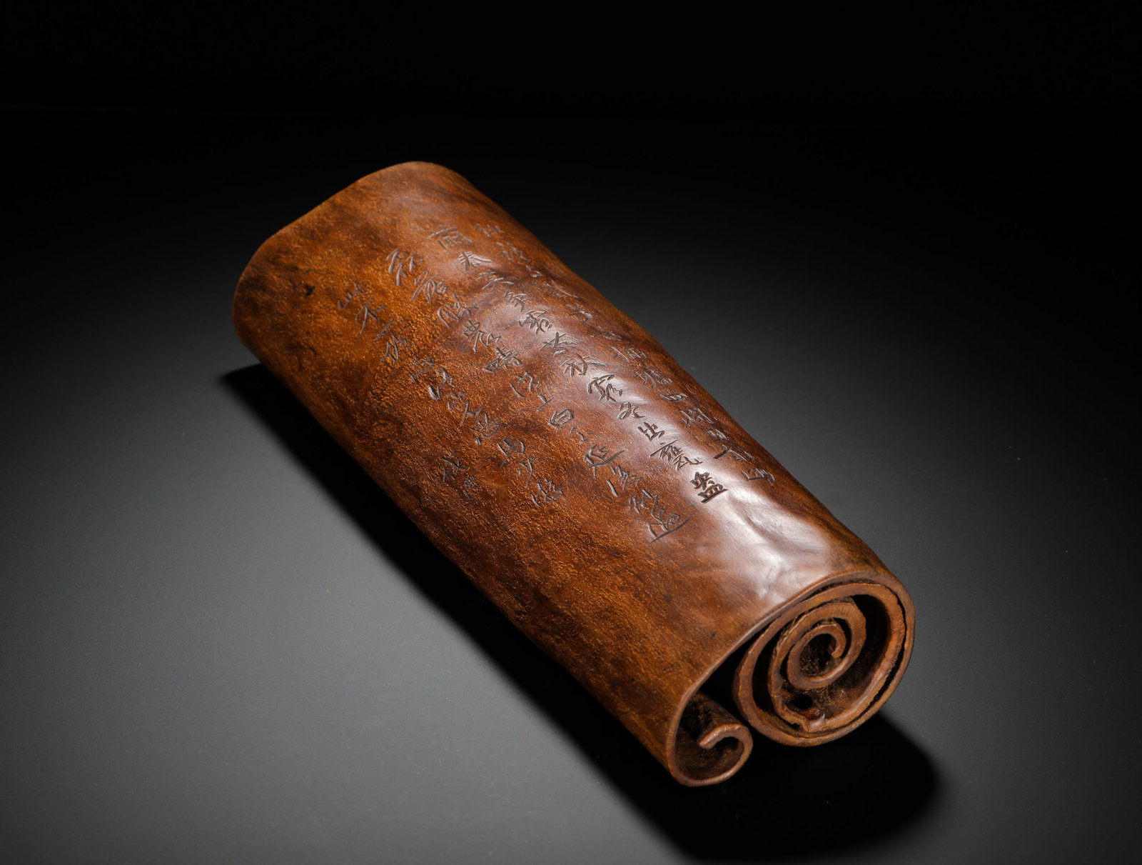 QING DYNASTY AGARWOOD BOOK-STYLE POETRY ARM REST: H:33cm (12.99in) W:12cm (4.72in) Weight:1110g (2.45lb)Natural agarwood wrist rest carved as antique scroll, incised with running script poetry.