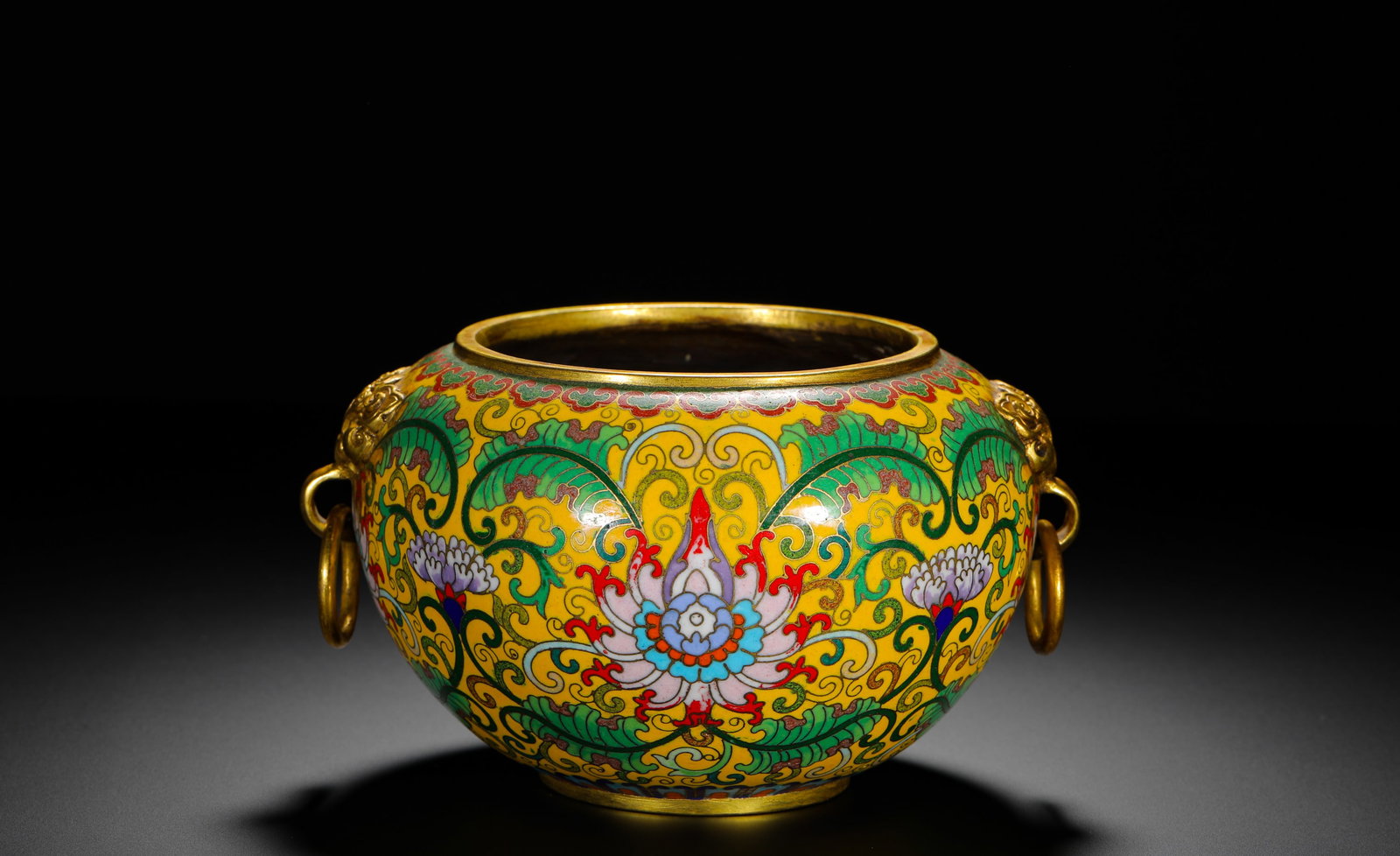 A COPPER BODY CLOISONNE ENAMEL YELLOW GROUND LOTUS BEAST RING FURNACE MADE DURING THE QIANLONG: H:9cm (3.54in) D:17cm (6.69in) Weight:1620g (3.57lb)Gilt bronze censer with yellow cloisonne ground, scrolling lotus, twin movable beast-ring handles, four-character Qianlong reign mark.