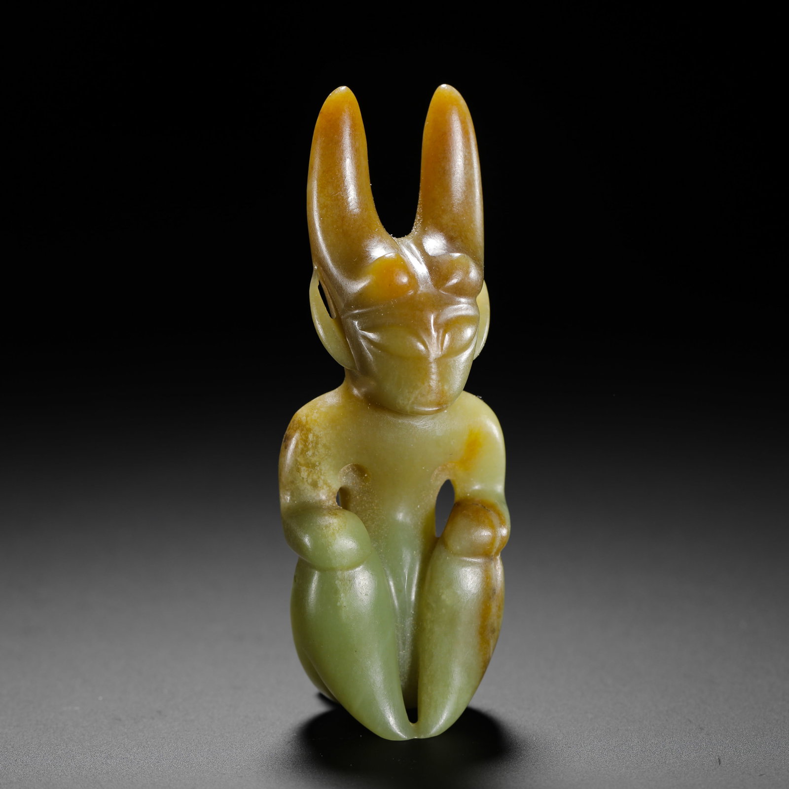 HONGSHAN CULTURE SUN GOD JADE FIGURE: H:8.7cm (3.43in) W:3.3cm (1.30in) Weight:70g (0.15lb)Yellow-green serpentine jade with smooth compact texture. Natural yellowish-brown raw jade patina remains on the twin horns and partial torso, dott