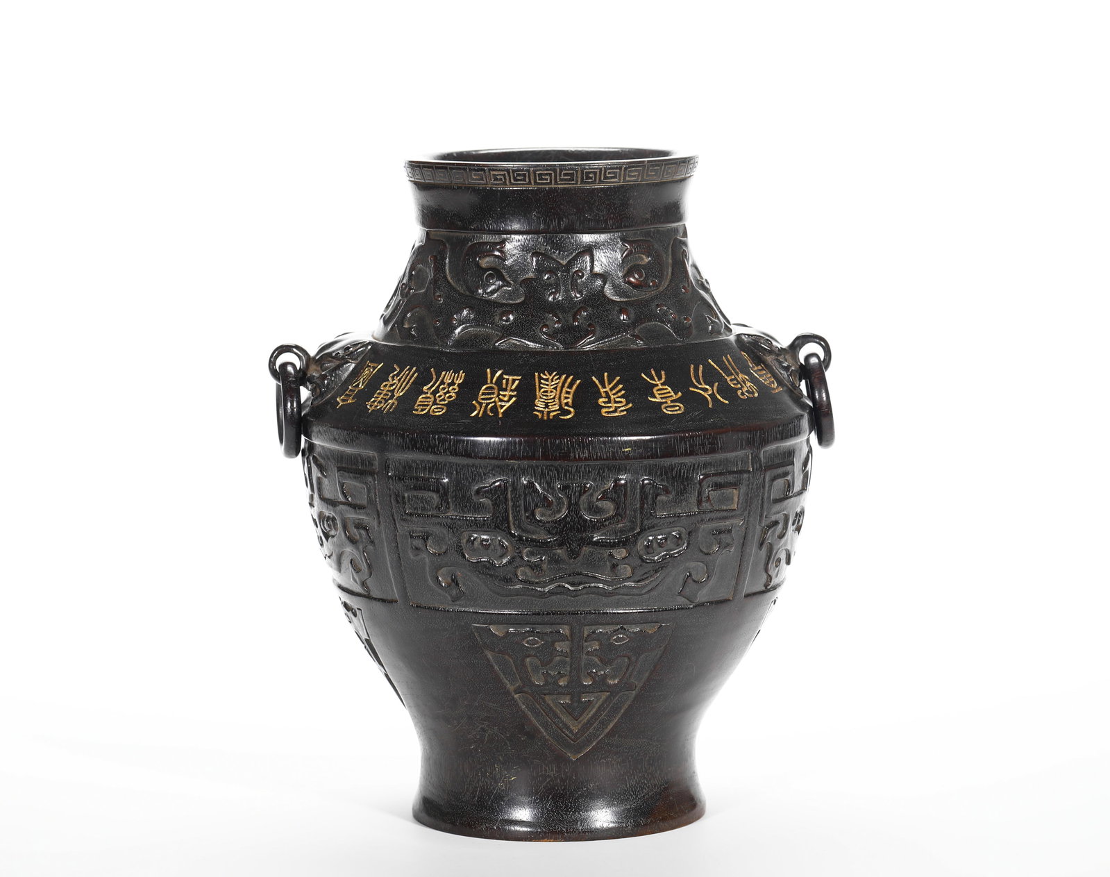 QING DYNASTY SANDALWOOD IMITATION BEAST FACE RING INSCRIPTION VASE: H:23cm (9.06in) D:20cm (7.87in) Weight:1620g (3.57lb)Solid zitan carved into archaic bronze zun shape, with relief taotie ornament and gilded seal-script inscription.