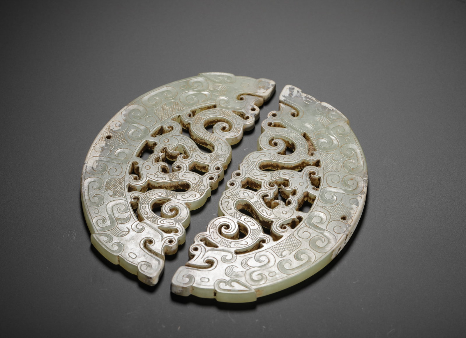 HAN DYNASTY HETIAN JADE PIERCED DRAGON AND PHOENIX PATTERN PENDANT: H:11cm (4.33in) W:12cm (4.72in) Weight:130g (0.29lb)H:11cmW:12cmWeight:130g These paired huang pendants are authentic jade artifacts from the Warring States to Han Dynasty, crafted from lustrous Hetia