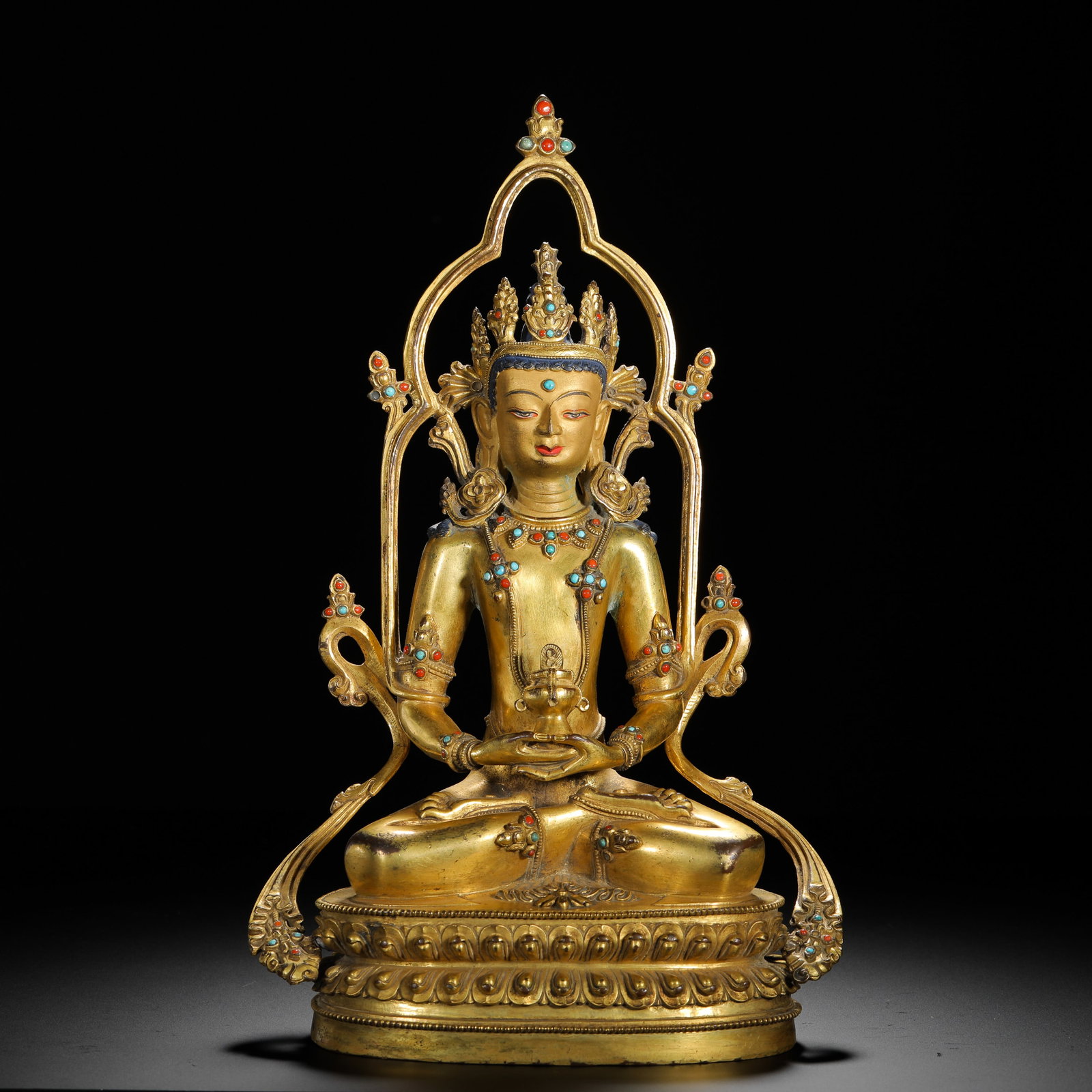A GILDED BRONZE STATUE OF THE BUDDHA OF INFINITE LIFE FROM THE QING DYNASTY: H:30cm (11.81in) W:19.5cm (7.68in) Weight:2450g (5.40lb)This is a Qing Dynasty gilt bronze seated statue of Amitayus in the Tibetan Buddhist style, featuring exquisite craftsmanship and ornate decorat