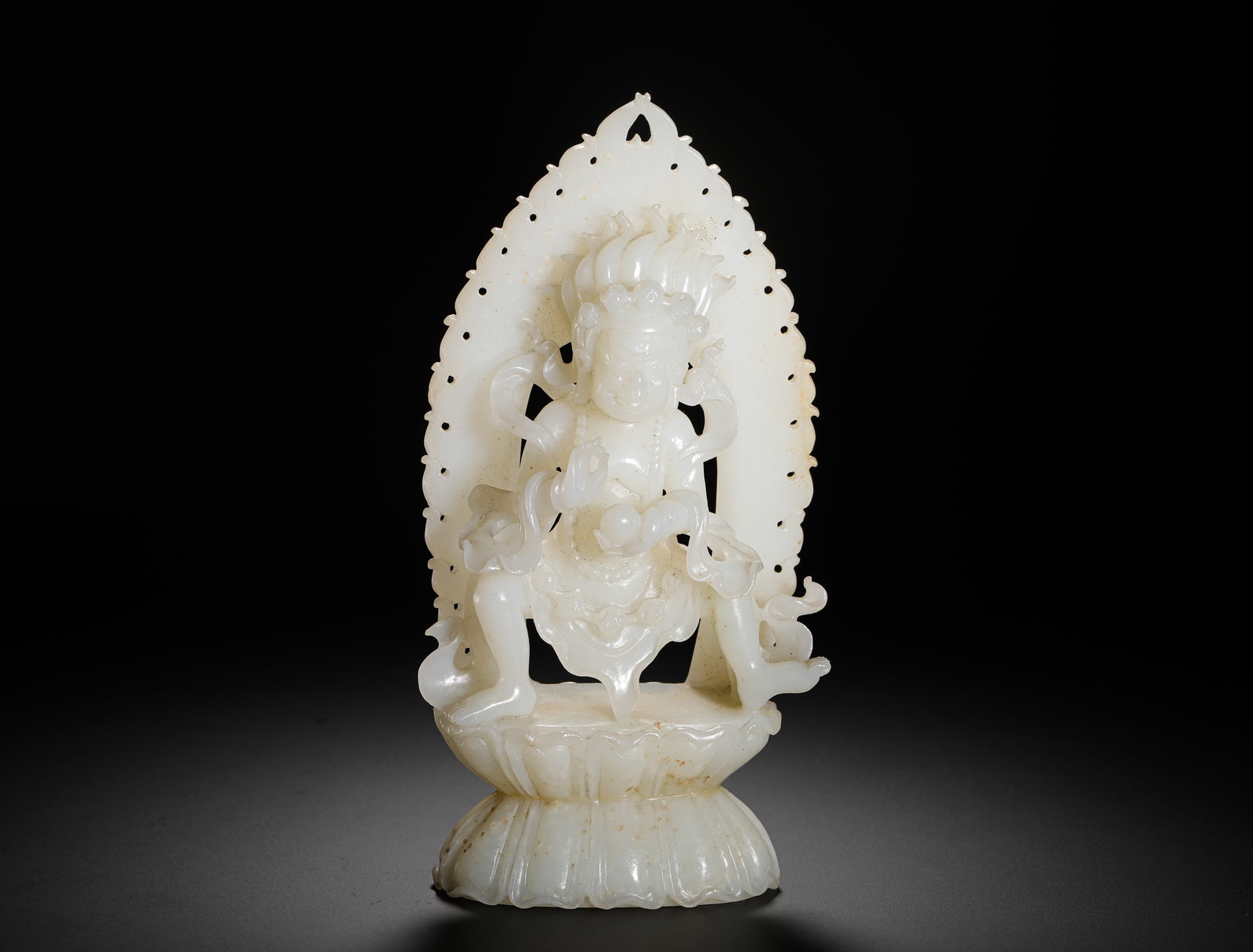 HETIAN JADE STATUE OF THE YELLOW GOD OF WEALTH FROM THE QING DYNASTY: H:17cm (6.69in) W:9cm (3.54in) Weight:460g (1.01lb)This statue is a Buddhist-themed jade work from the Qing Dynasty, crafted from lustrous Hetian celadon white jade. Seated in the lalitasana pose with
