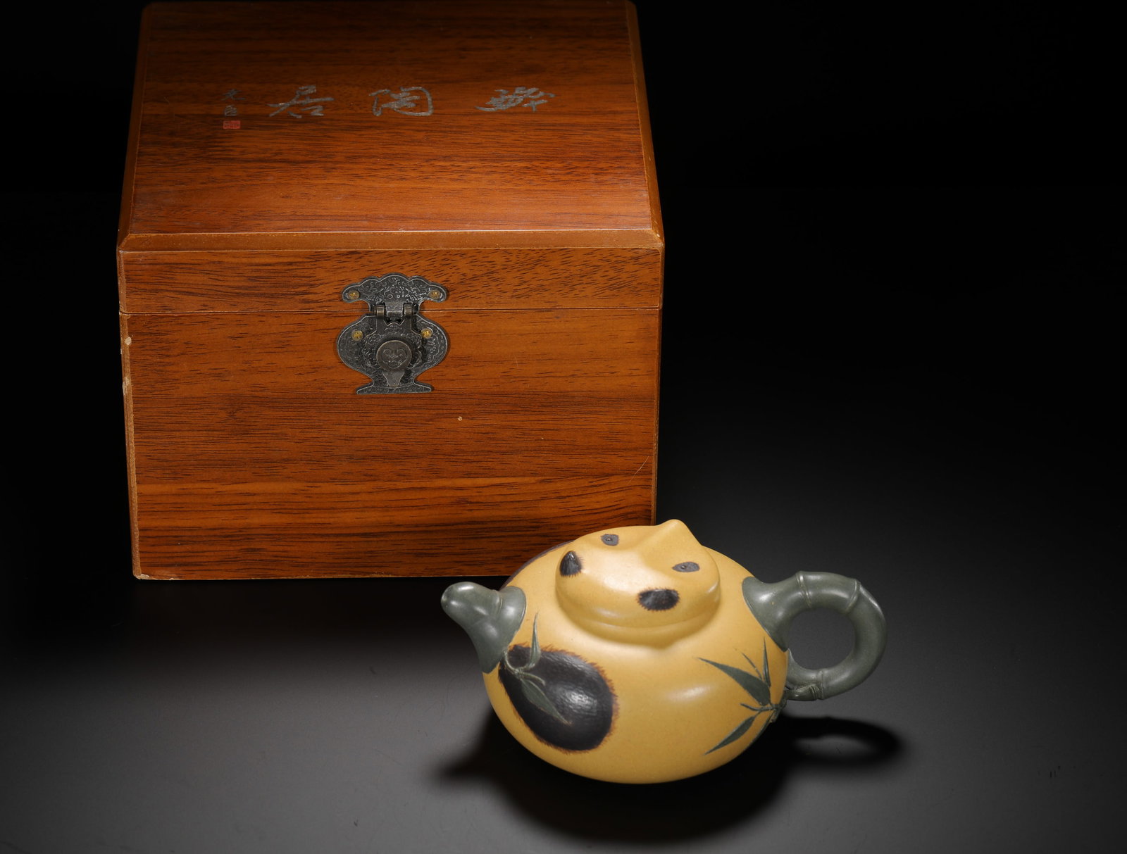 LU YAOCHEN PANDA BAMBOO JOINT PURPLE CLAY TEAPOT: H:8cmW:16.5cmWeight:280g Creative biomorphic floral Zisha teapot with matching original poetry wooden collection box. The body is made of natural golden Benshan Duan clay, decorated with green clay to