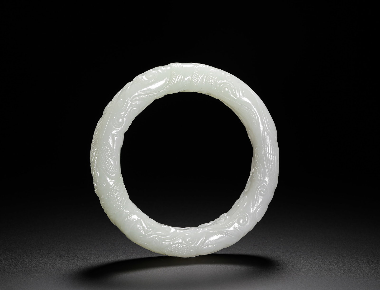 QING DYNASTY HETIAN JADE DRAGON PATTERN BRACELET: D:9cm (3.54in) D:6cm (2.36in) Weight:100g (0.22lb)This bangle is a classic jade work from the Qing Dynasty, crafted from lustrous Hetian celadon white jade. It features finely carved dragon motifs, ex