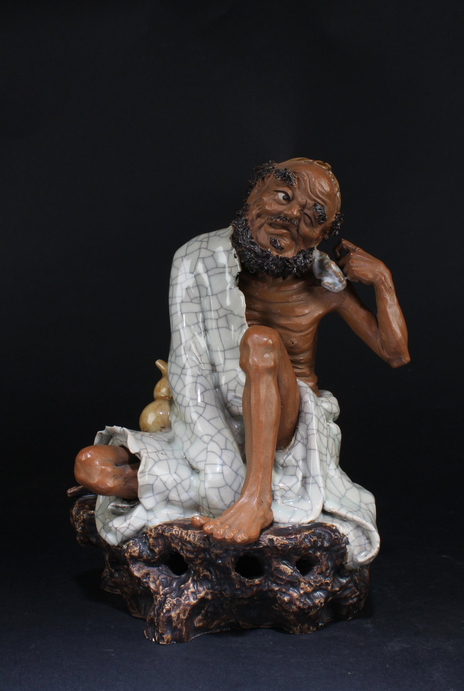 A Shiwan Figurine: A Shiwan Figurine. Height: 9.5" Width: 7.5"