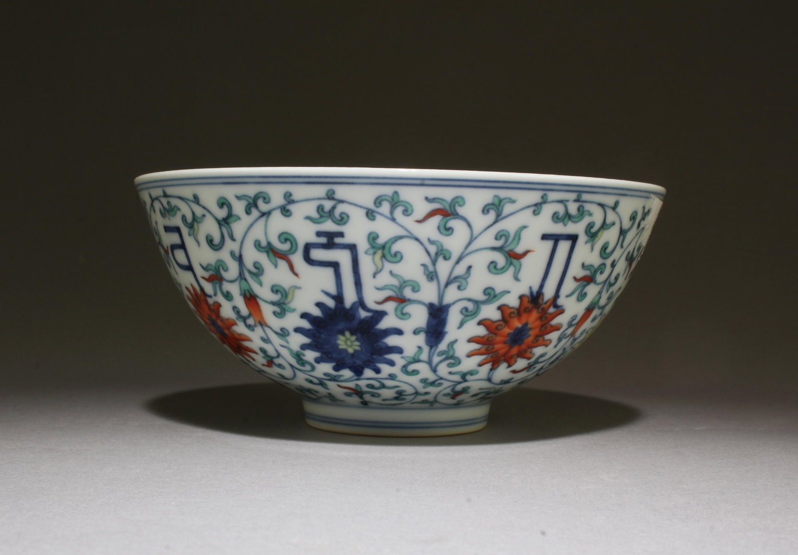 Antique Chinese Famille Rose Bowl: Of rounded sides, the deep potted bowl is decorated with polychrome flower blossoms bourne with leafy stems. 'YongZheng' mark at base. Diameter: 5.75 "