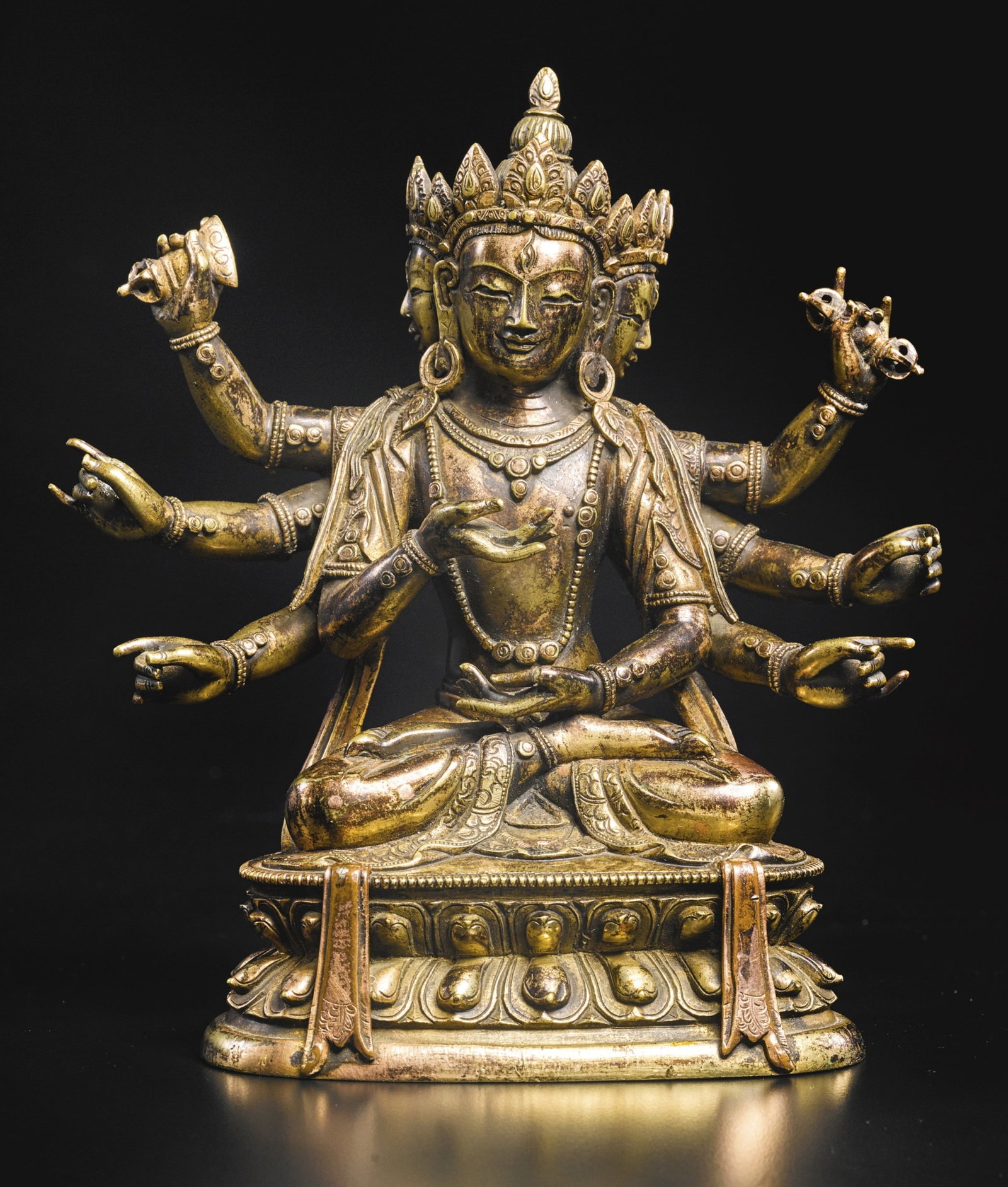 18th C Bronze Manjuvarja Figure: 18th C Bronze Manjuvarja Figure Tibeto-Chinese. The deity with three faces and eight arms, seated in vajraparyanksana on a double lotus throne, with long plaits cascading down the shoulders, wearing t