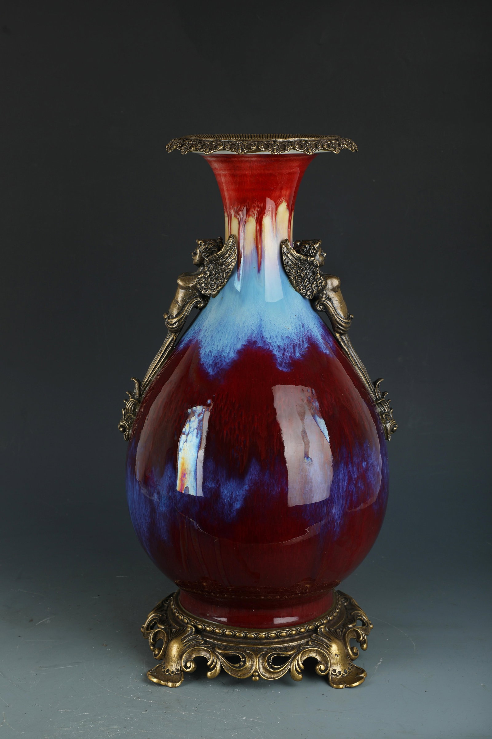A Porcelain Vase: A Porcelain Vase, with brass ormolu. 'QianLong' mark at base. Height: 18.5"
