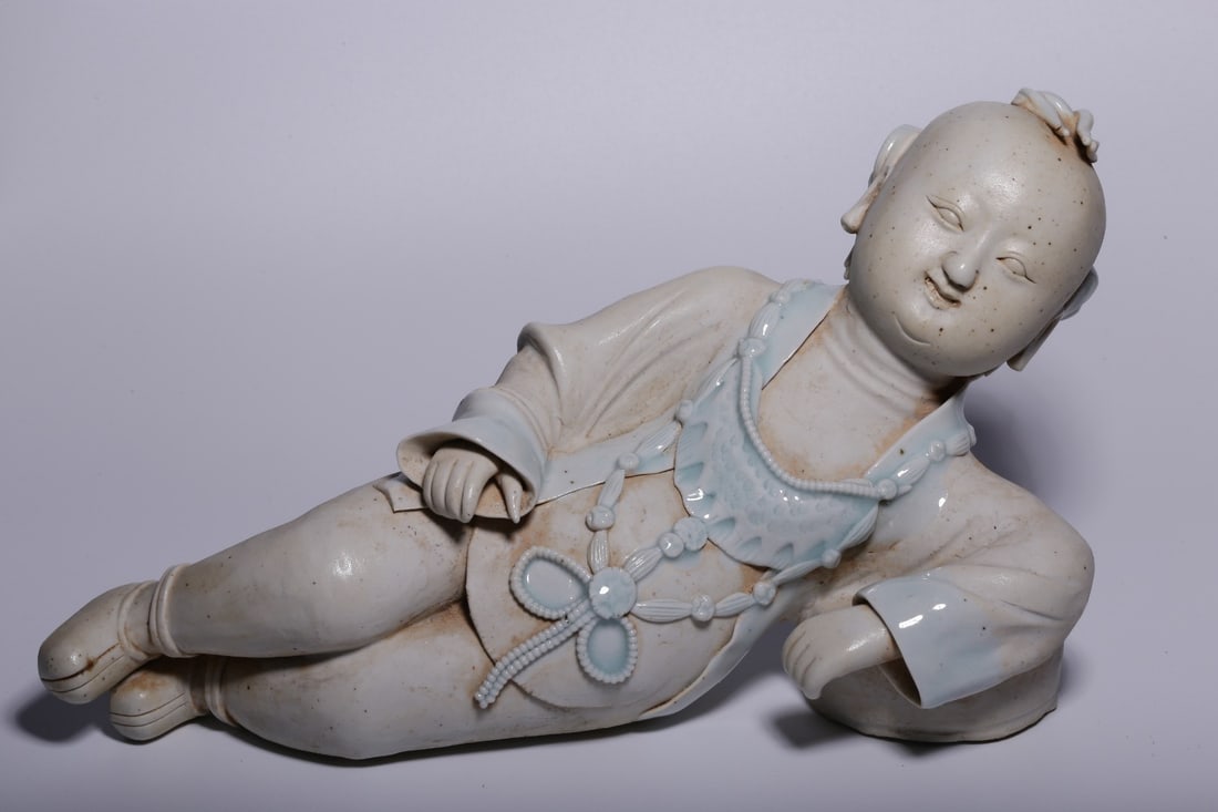 A Hutian Ware Reclining Boy Figure: Height: 6.02in; Length: 10.51in; Width: 4.33in; Weight: 3.01lbs.
