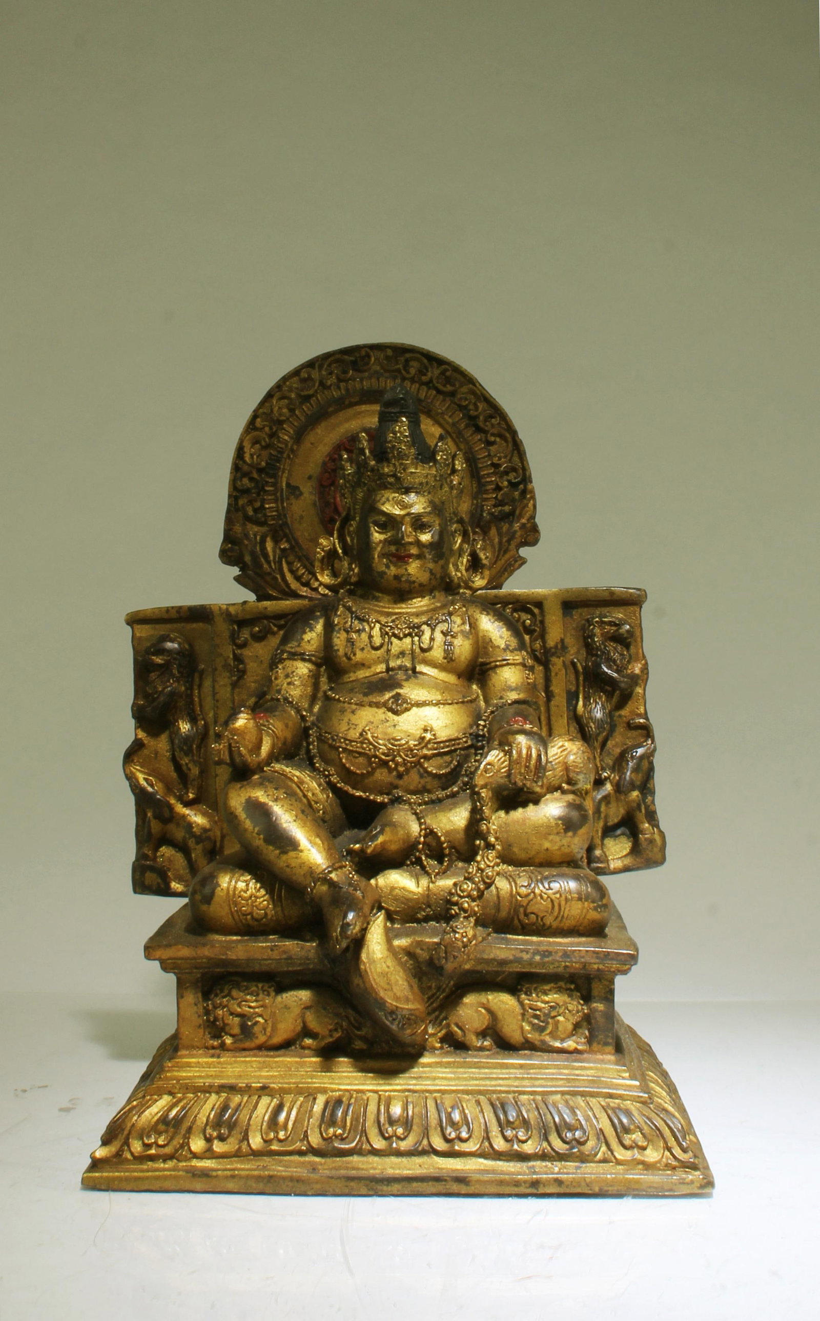 A Bronze Deity Statue: A Bronze Deity Statue. Height: 12" (without back panel) Length: 14"
