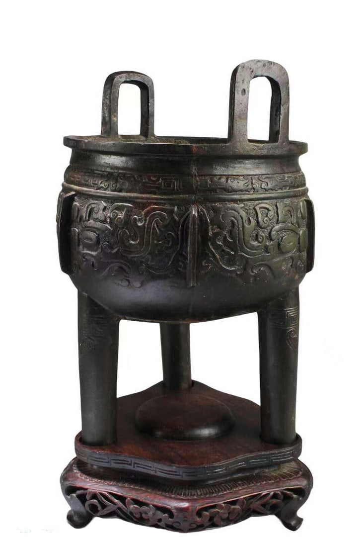Antique Bronze Tripod Censer: Antique Bronze Tripod Censer, flanked by twin handles, the interior is inscribed with ancient characters. Comes fitted with a wooden base. Height: 1.25" Diameter: 6.75"
