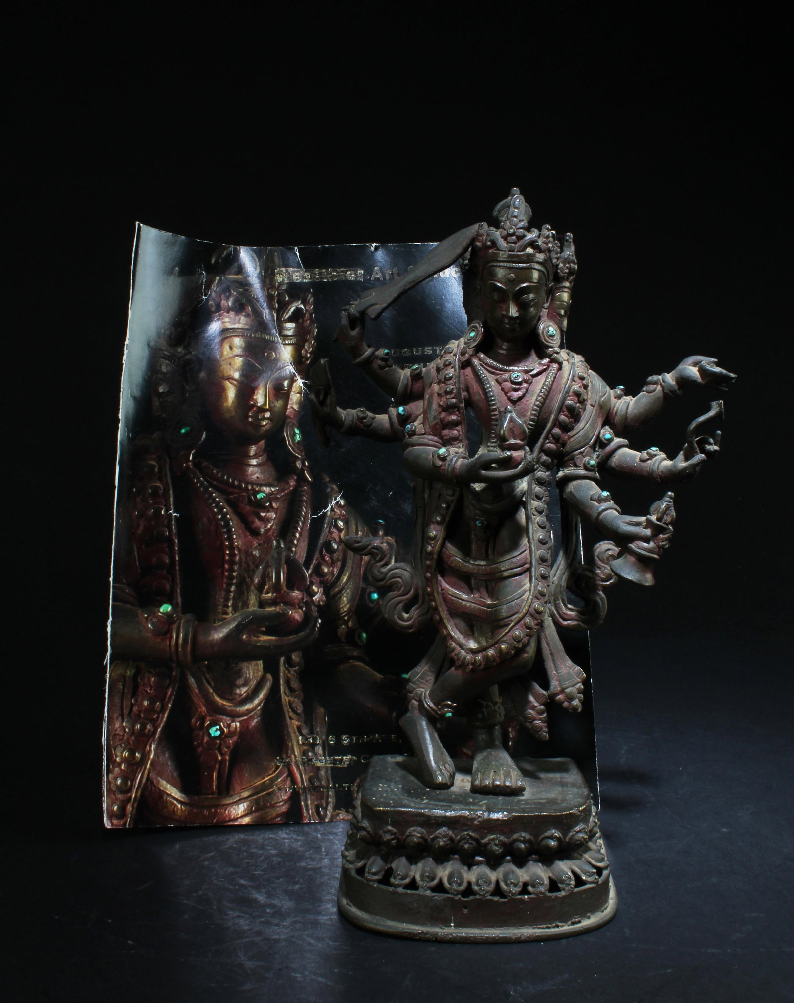 18-19th Antique Bronze Buddha Vasudhra: The three headed bodhisattva standing on a lotus base, the principle hands in dharmachakramudra, the other hands in vitarkamudra, dhyanamudra, veradamudra and abhayamudra, wearing a dhoti and a long