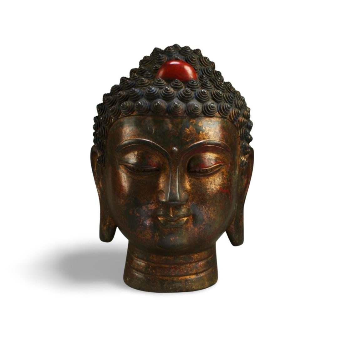 A Bronze Buddha Head: A Bronze Buddha Head. 'QianLong' mark at base. Height: 14.5"