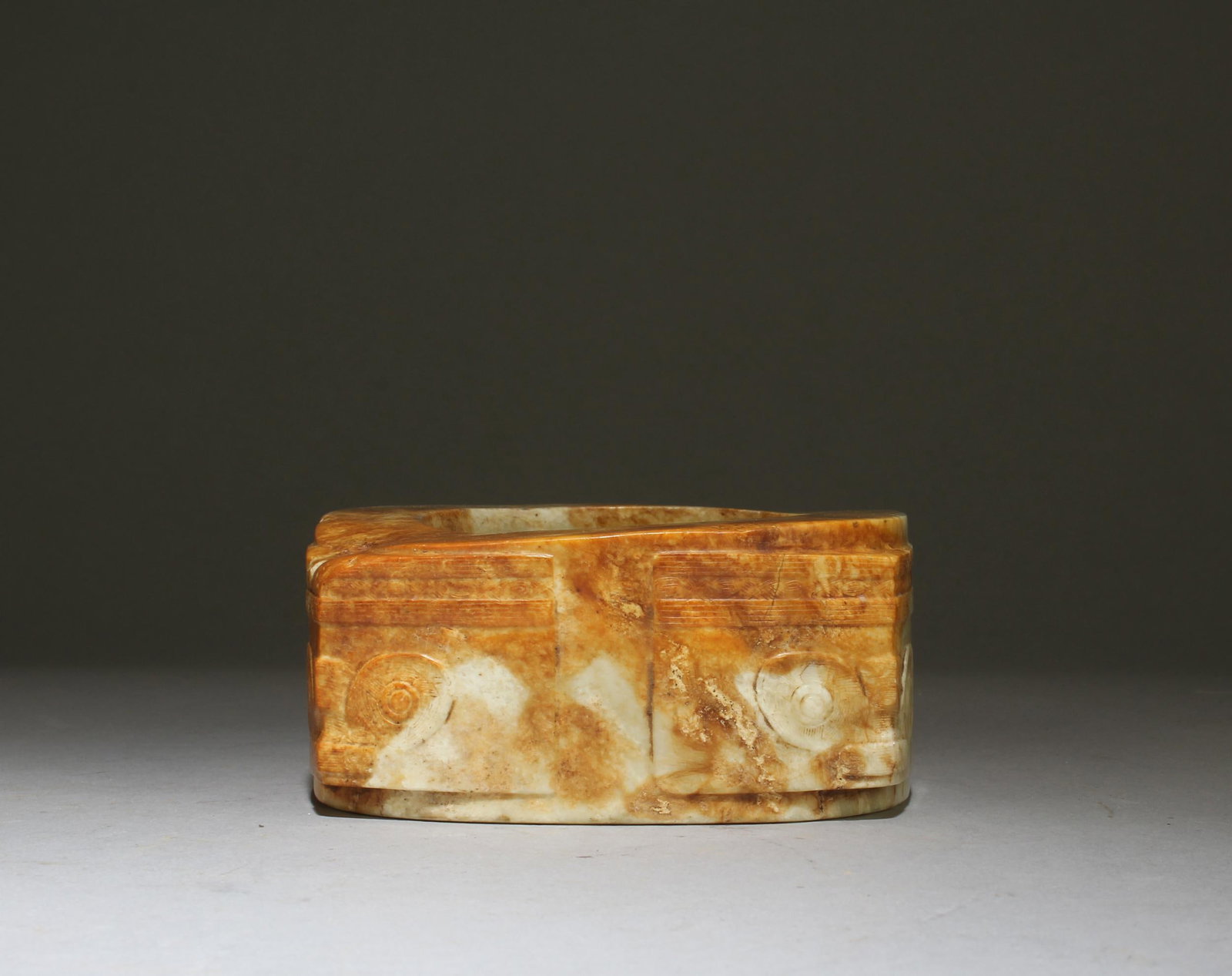 A Carved Jade 'Cong': A Carved Jade 'Cong'. Height: 2.01in. Length: 4.02in.