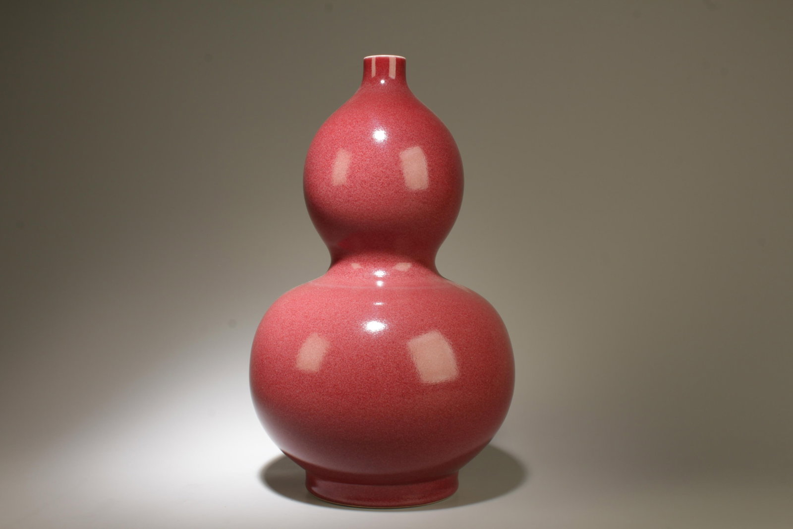 A Red Double-Gourd Vase: A Red Double-Gourd Vase. Dimension: 14.5" x 9".