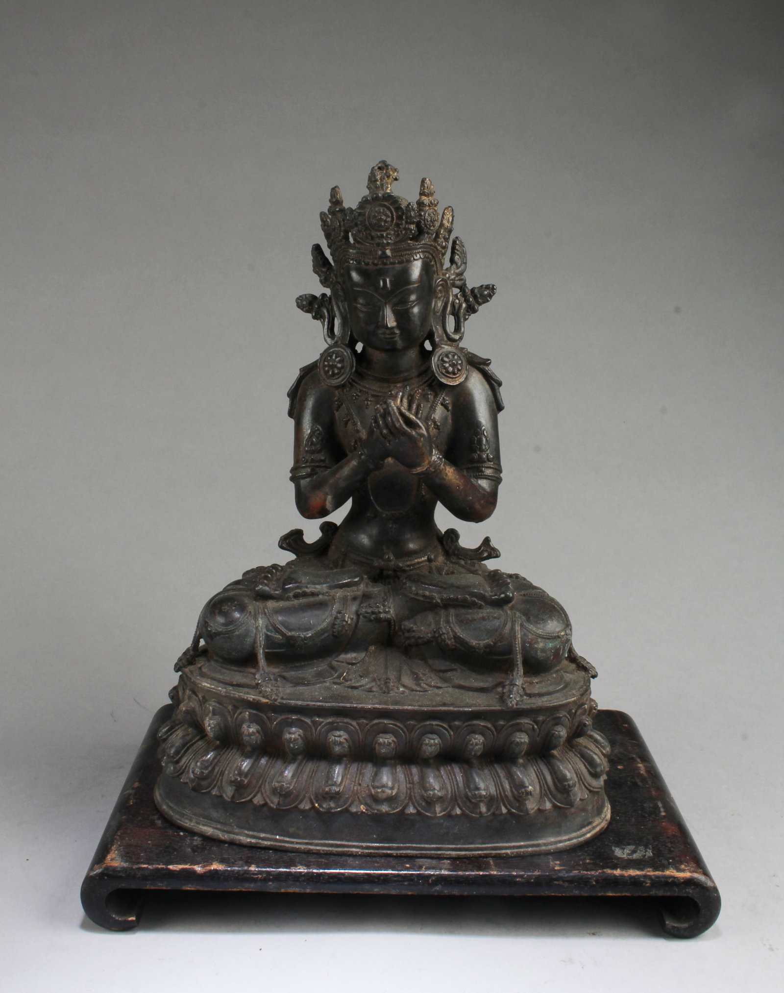A Bronze Bodhisattva Statue: A Bronze Bodhisattva Statue. Comes fitted with a wooden stand. Height: 12.75"