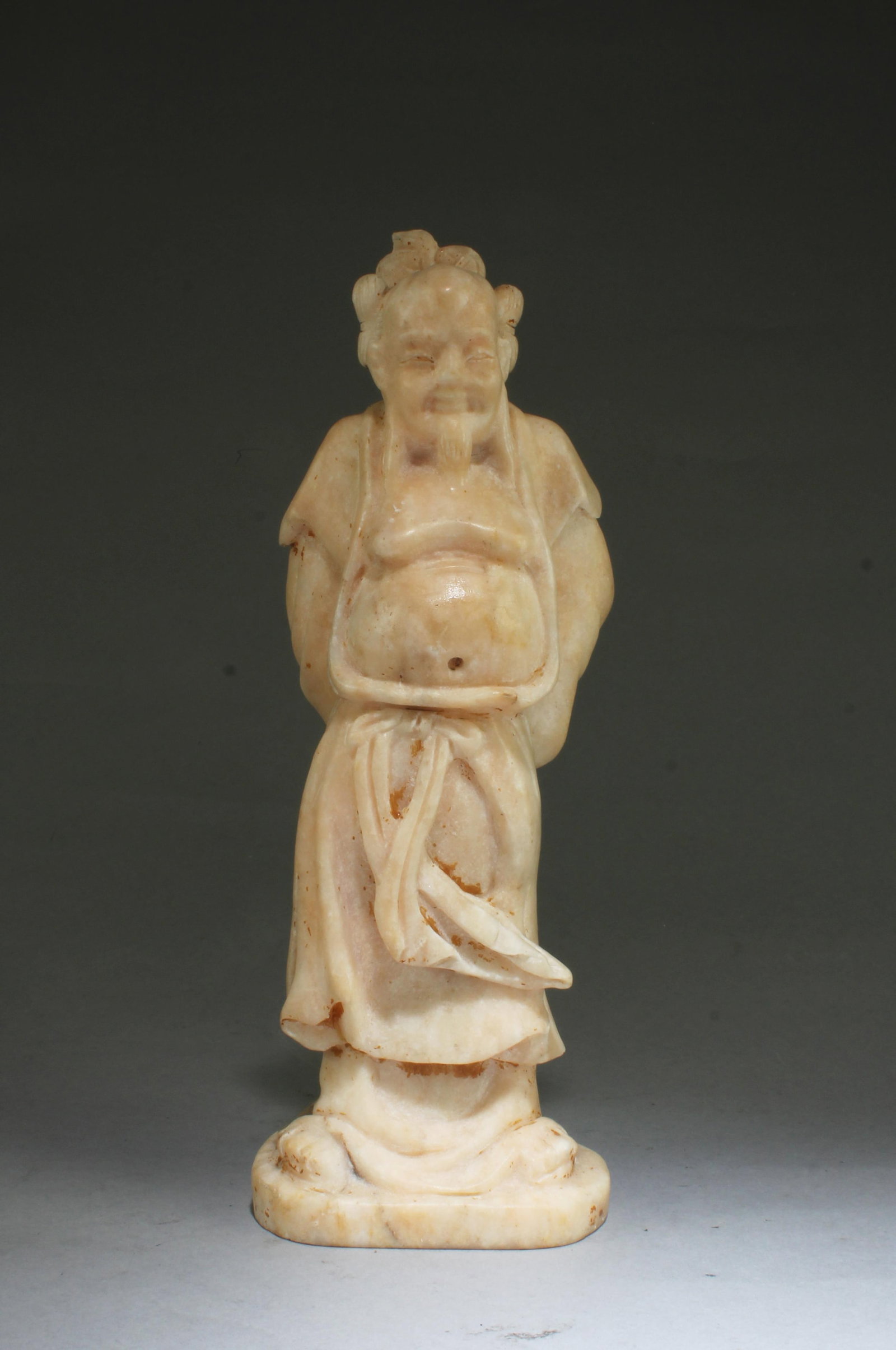 Chinese Soapstone Statue: Chinese Soapstone Statue, depicting an immortal wearing flowing robes, with the front chest exposed, in standing position. Height: 10.5"