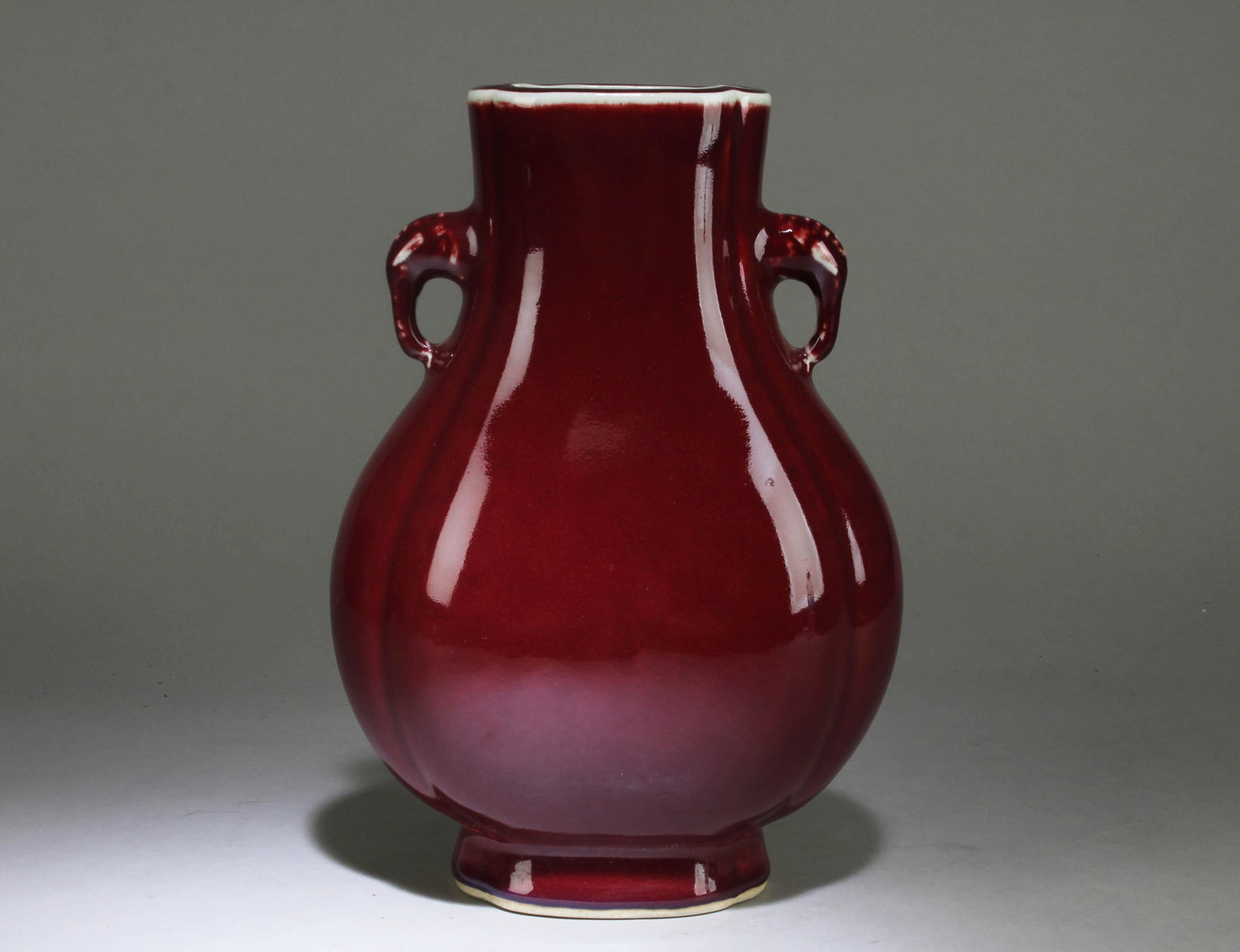 A Chinese Red Ceramic Vase: A Chinese Red Ceramic Vase.. Dimension: 11" x 7.5" x 5.25".