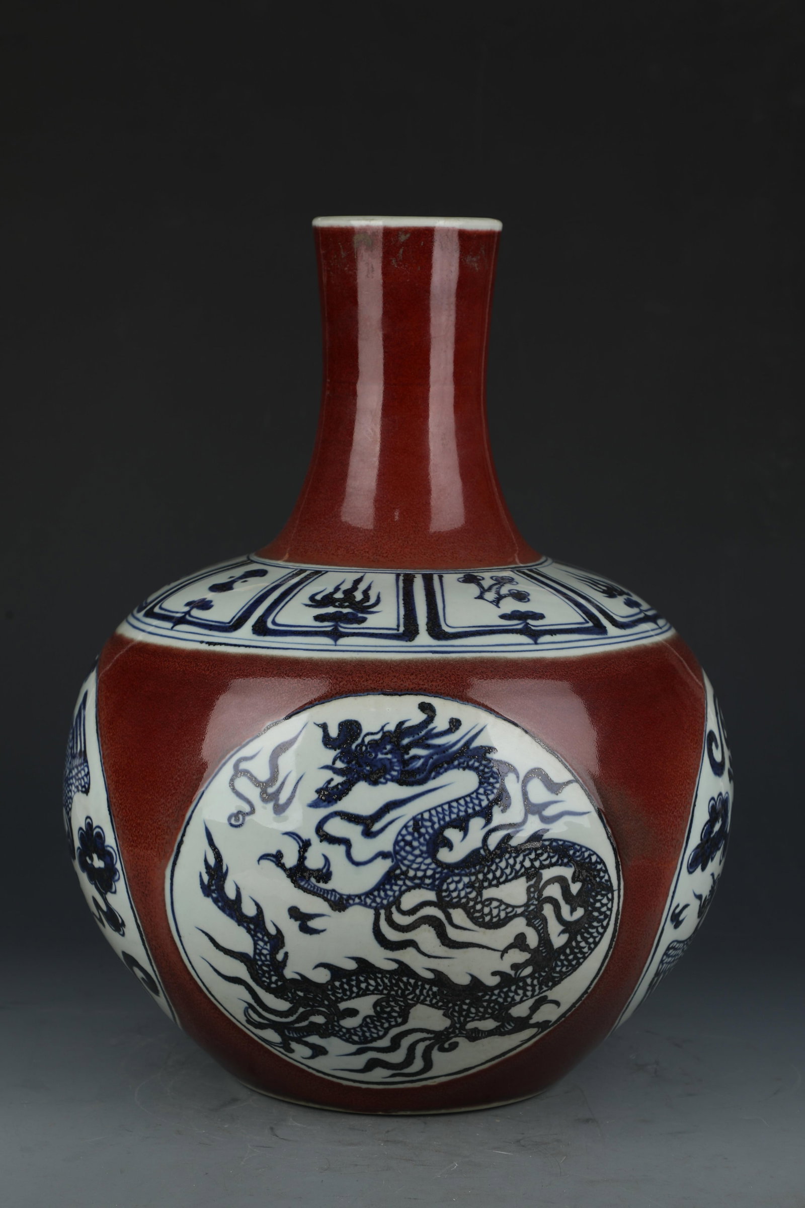 A Blue and Red Celestial Sphere Vase: A Blue and Red Celestial Sphere Vase with Dragon Motif. Dimensions: 18" x 12.5".