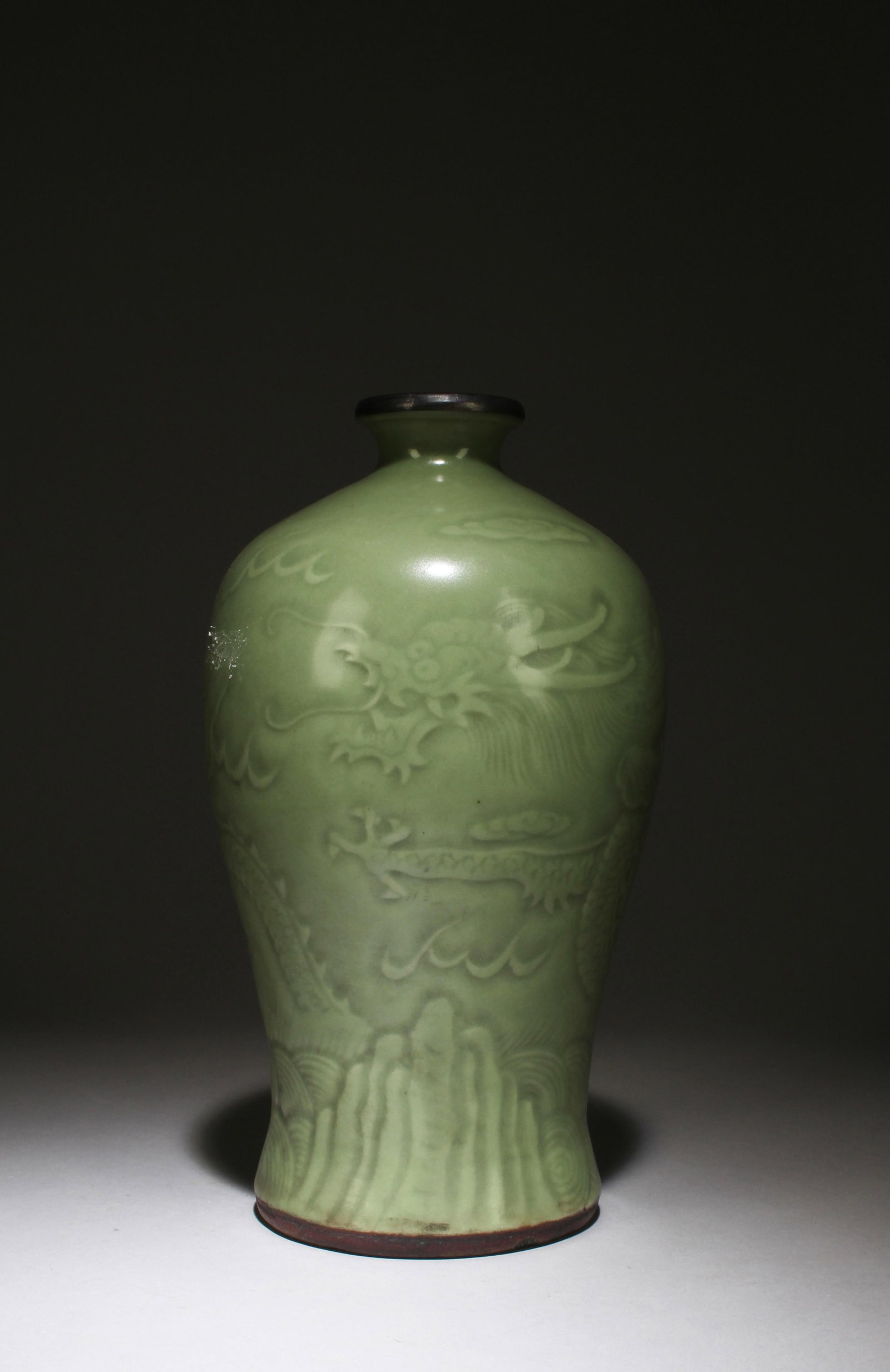 A Celadon Vase: A Celadon Vase, mouth rim with bronze lining. Height: 9.84in. Diameter: 5.12in.