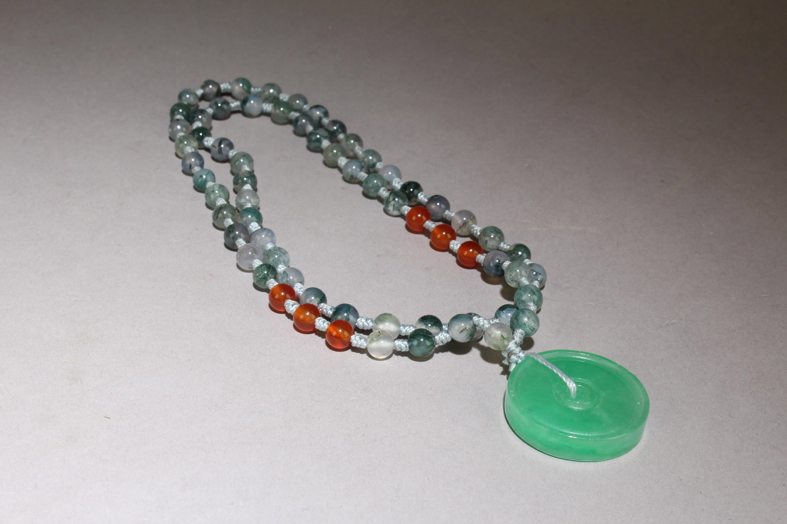 A Jade Necklace: A Jade Necklace. Dimensions: Jade Size: 1.25", Lace Length Top To Bottom: 12.75".