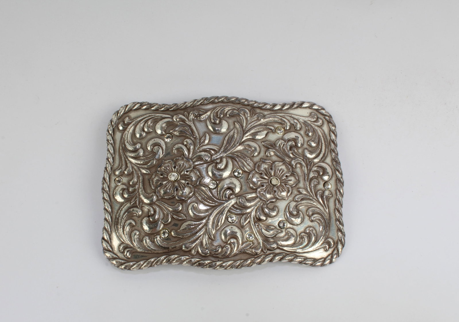 A Belt Buckle: A Belt Buckle. Has 11 diamonds engraved. Length: 3.5" Height: 2.5"