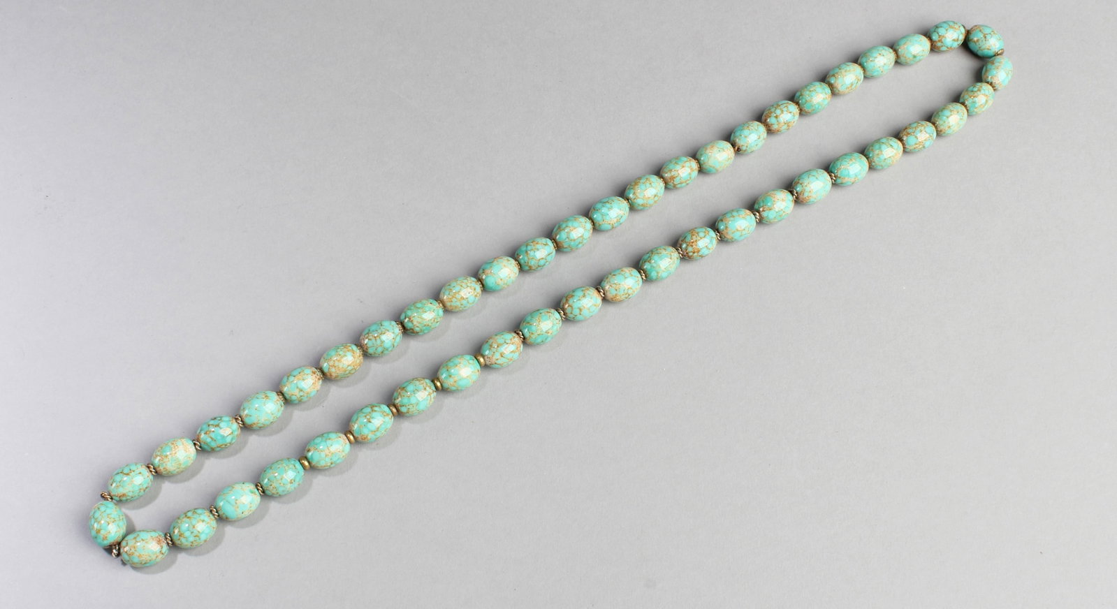 Chinese Beaded Necklace: Chinese turquoise beaded necklace, round beads of similar size in dappled colors of green, blue and grey, divided by small gold colored beads and strung closely together in single strand. Length: 47 "