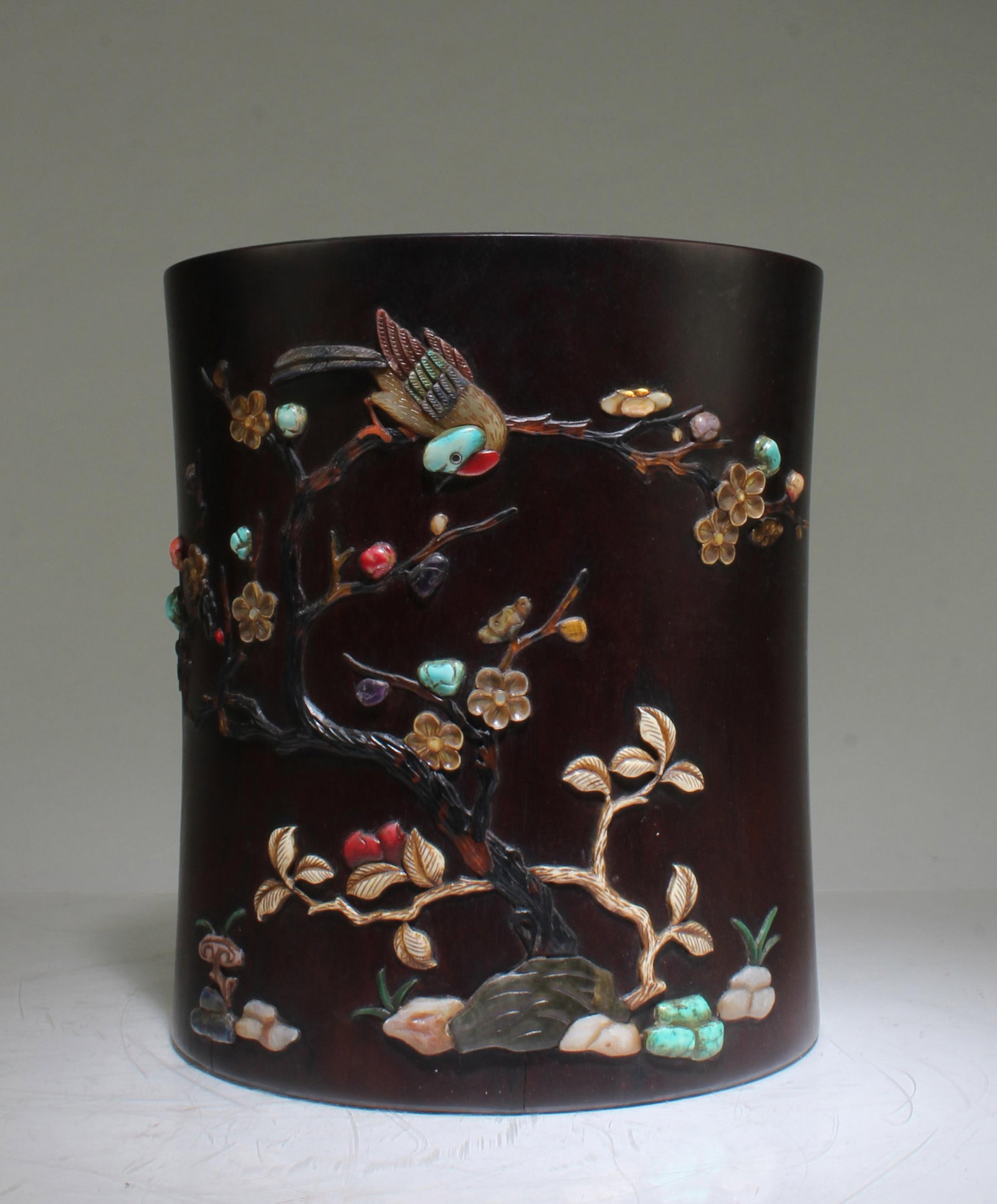 A Carved Wooden Brushpot: A Carved Wooden Brushpot, the body decorated with precious stones inlay. Height: 8.5" Diameter: 7.5"
