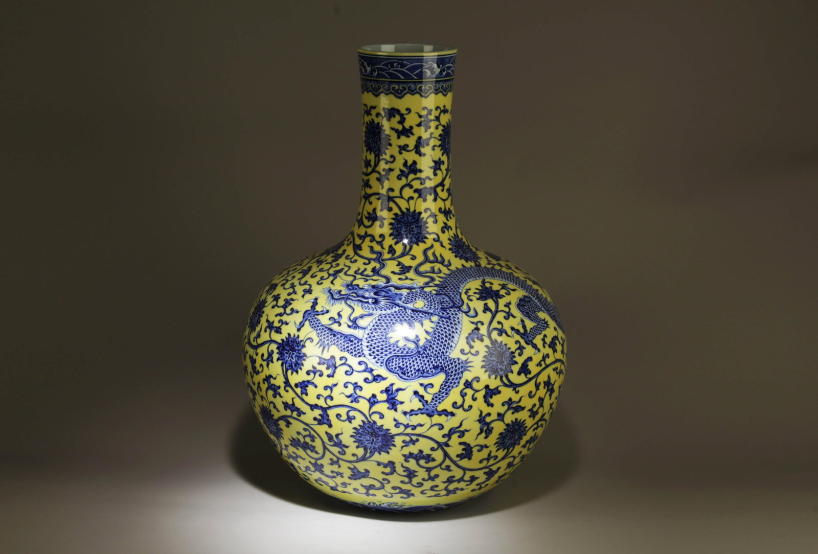A Blue and Yellow Dragon Vase: A Blue and Yellow Dragon Vase. Dimensions: 14.5" x 21".