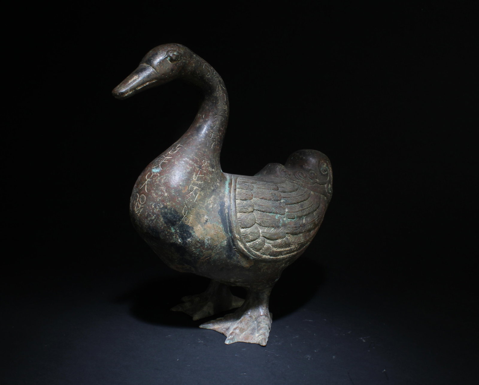 A Bronze Geese Statue Inscribed Chinese Characters: A Bronze Geese Statue with Inscribed Chinese Characters. Dimensions: 13" x 12".