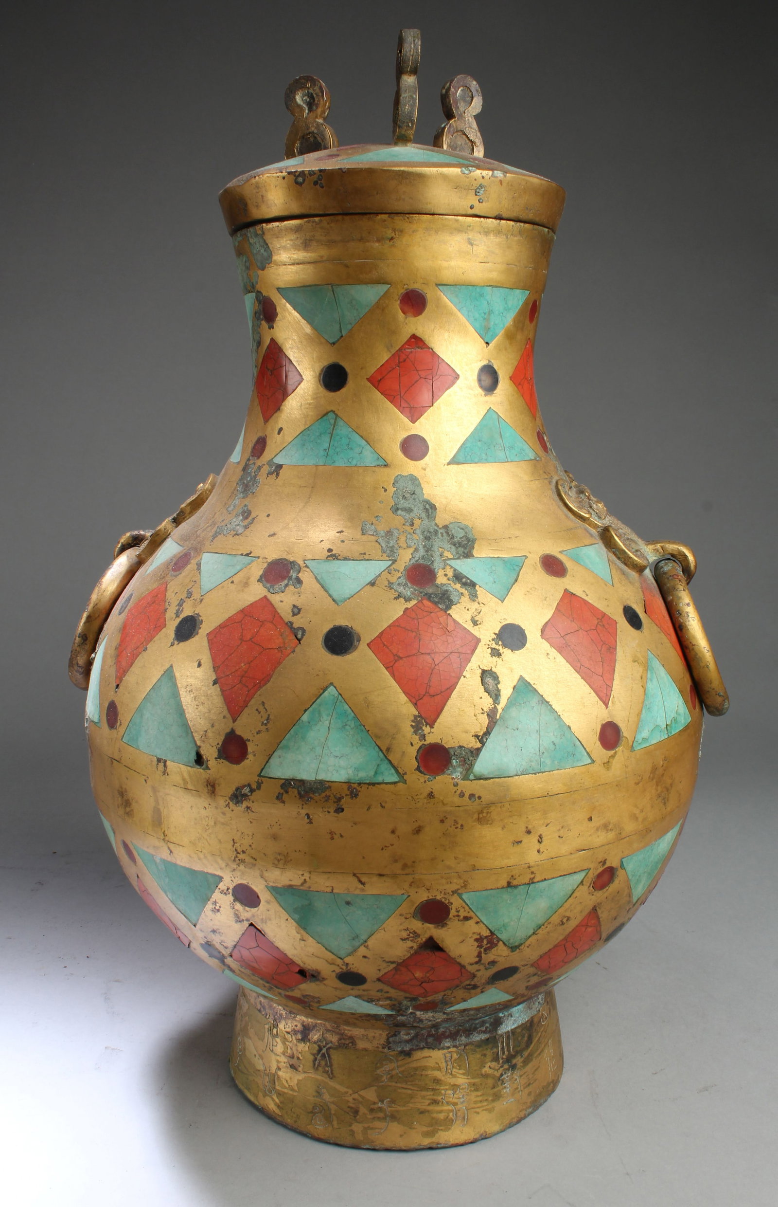 A Han Dynasty Gilt Bronze Jar with Lid Cover: A Han Dynasty Gilt Bronze Jar with Lid Cover, decorated with red and green turquoise, the circular foot is inscribed with ancient characters. Height: 18.75"Provenance: Private collector from Glendale,