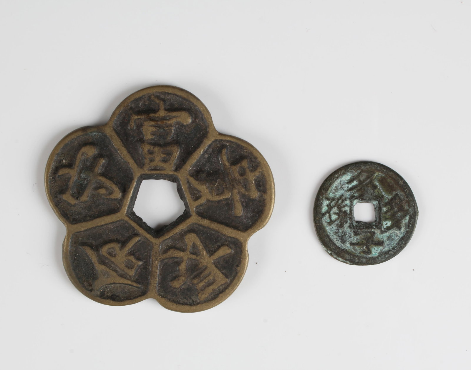 A Group of Two Chinese Coins: A Group of Two Chinese Coins. Diameter: 2" (Flower petal shaped)