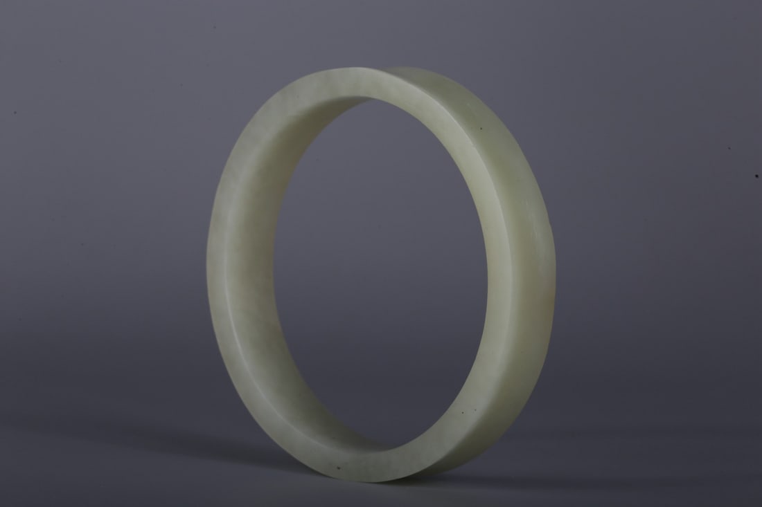 A Hetian White Jade Ring: A Hetian White Jade Ring. Height: 0.67in; Diameter: 3.74in; Weight: 0.19lbs.