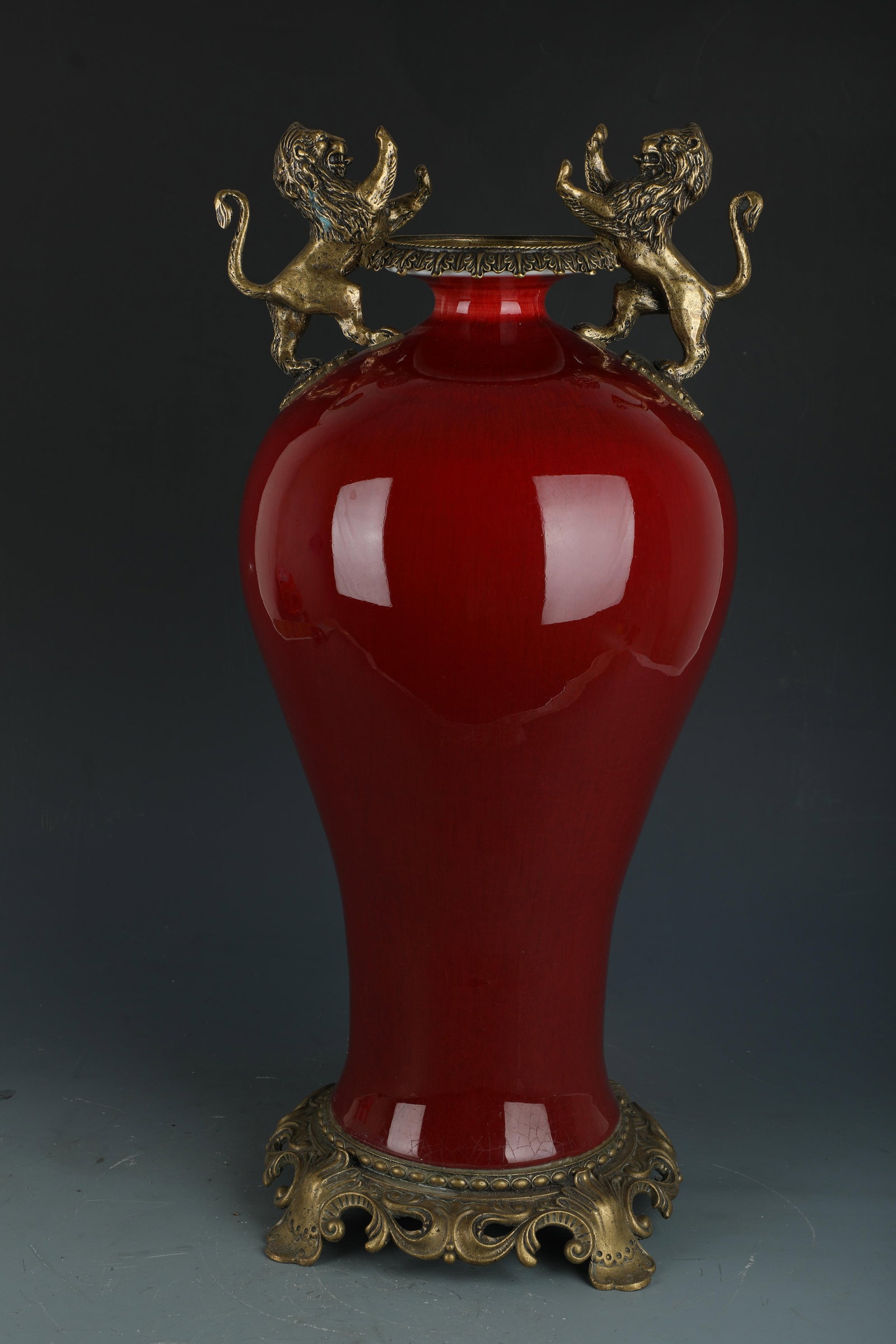 A Porcelain Vase: A Porcelain Vase, with brass ormolu. 'QianLong' mark at base. Height: 20" Diameter: 9" (Widest)
