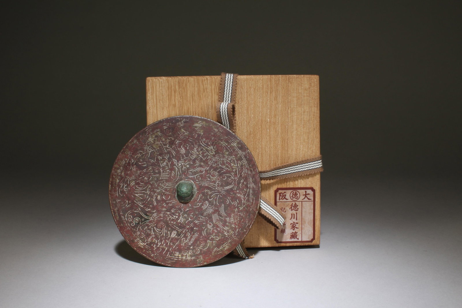A Bronze Round Mirror: A Bronze Round Mirror. Diameter: 5". Formerly collected by the noble Tokugawa family in the Kansai region of Japan. These goods were first hidden in a temple called Bodaiji in the Kansai region.
