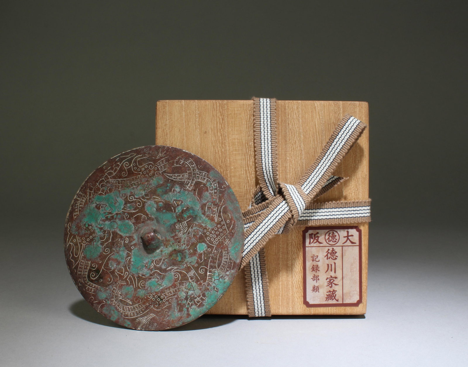A Bronze Round Mirror: A Bronze Round Mirror. Diameter: 4.4". Formerly collected by the noble Tokugawa family in the Kansai region of Japan. These goods were first hidden in a temple called Bodaiji in the Kansai region.