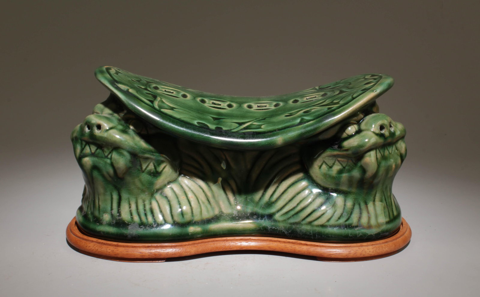 A Green Glazed Pillow: A Green Glazed Pillow. Dimension: 8" x 4.5" x 4" w/ stand.