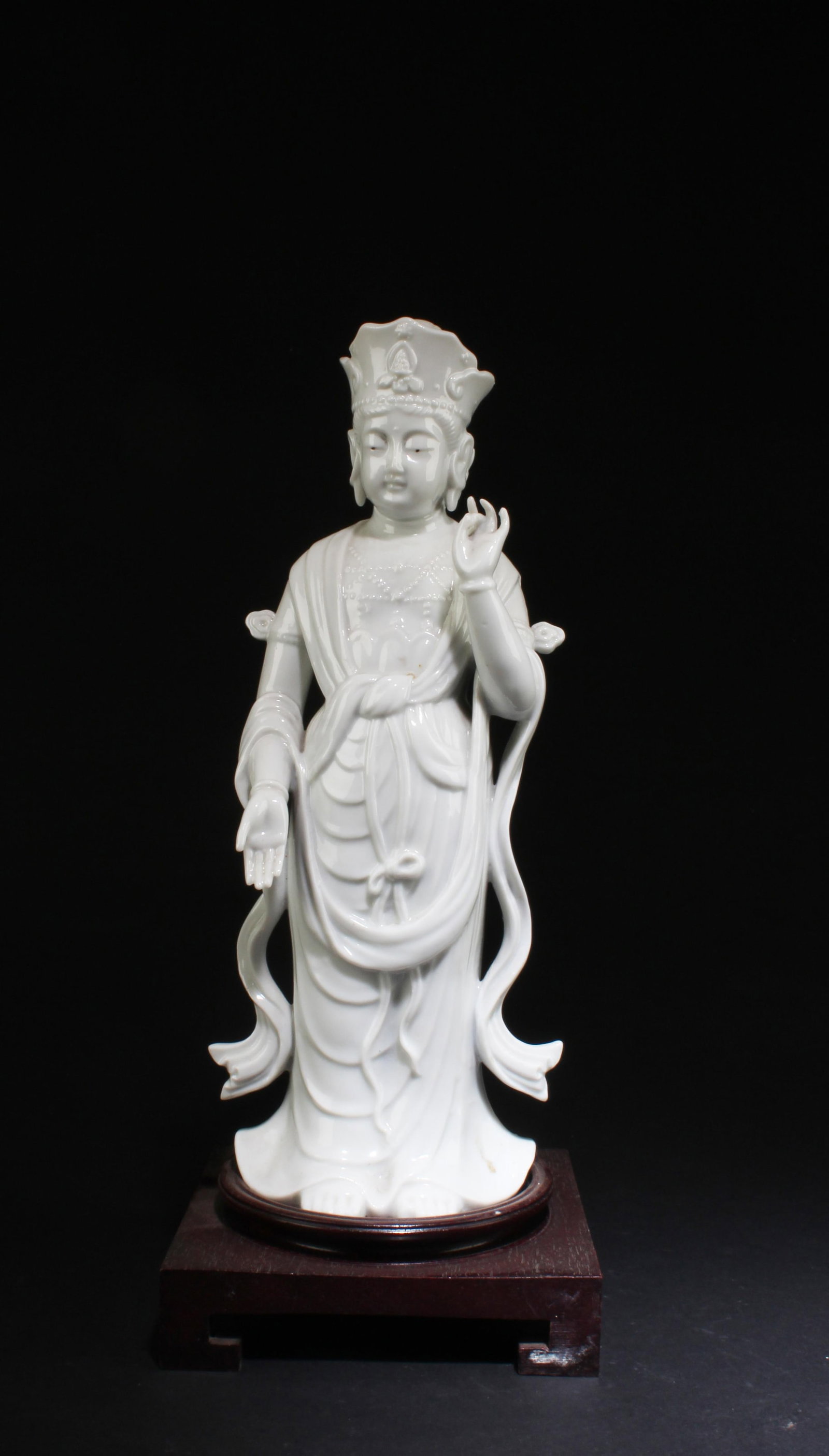 An Old Chinese Blanc De Chines Statue: An Old Chinese Blanc De Chines Standing Bodhisattva Statue. Comes Fitted with a wooden stand. Height: 11.5" (with stand)