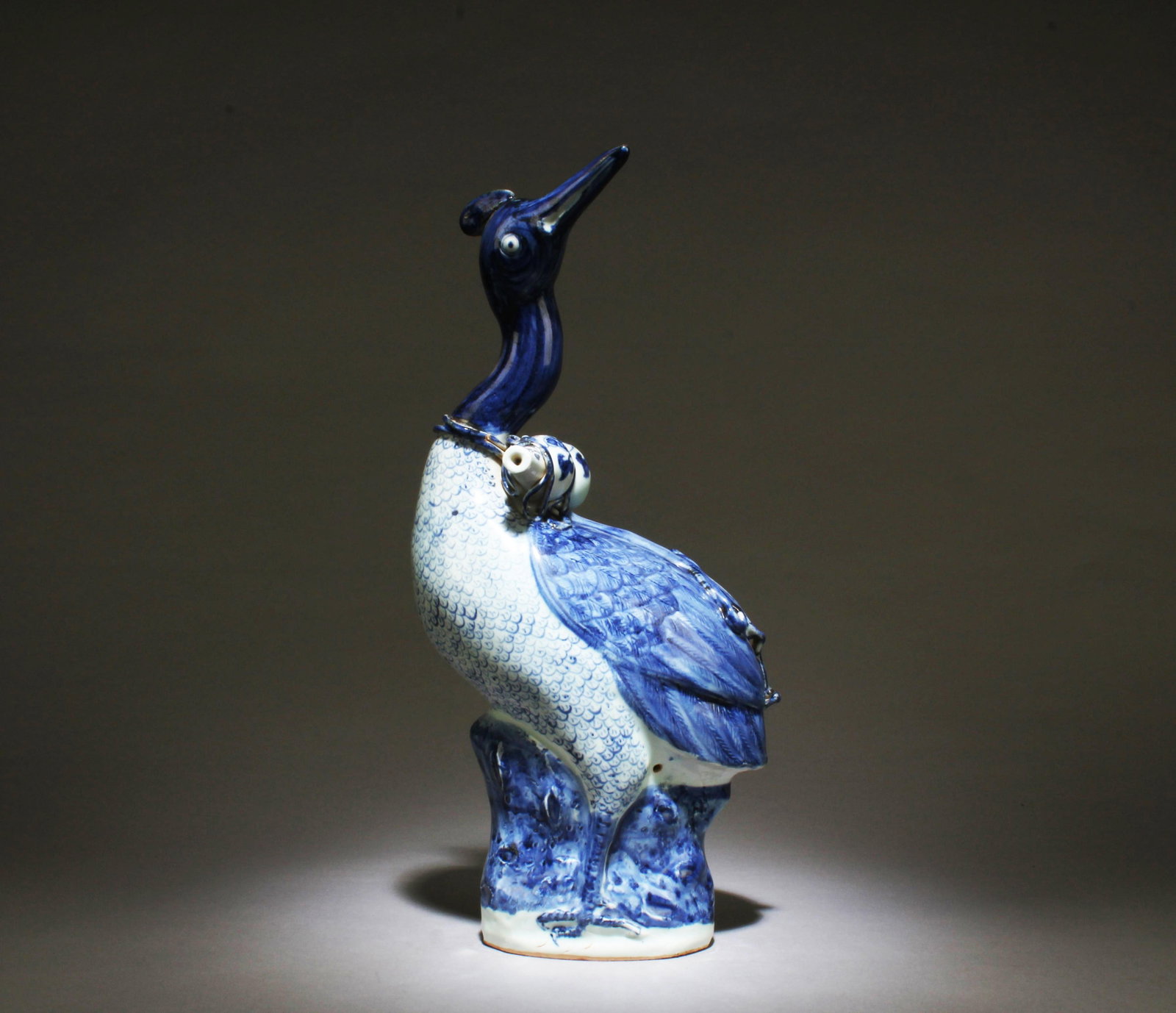 A Blue and White Bird Ornament: A Blue and White Bird Ornament. Dimensions: 15.25" x 7.5" x 4.75".