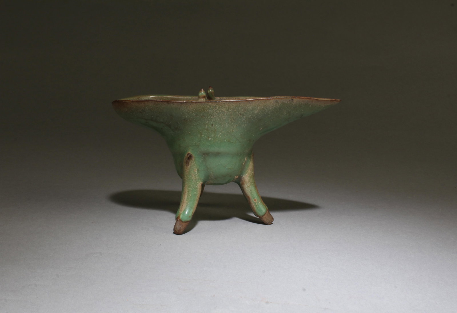 A Glazed Tripod Vessel: A Glazed Tripod Vessel. Length: 6.2" Height: 3.75"