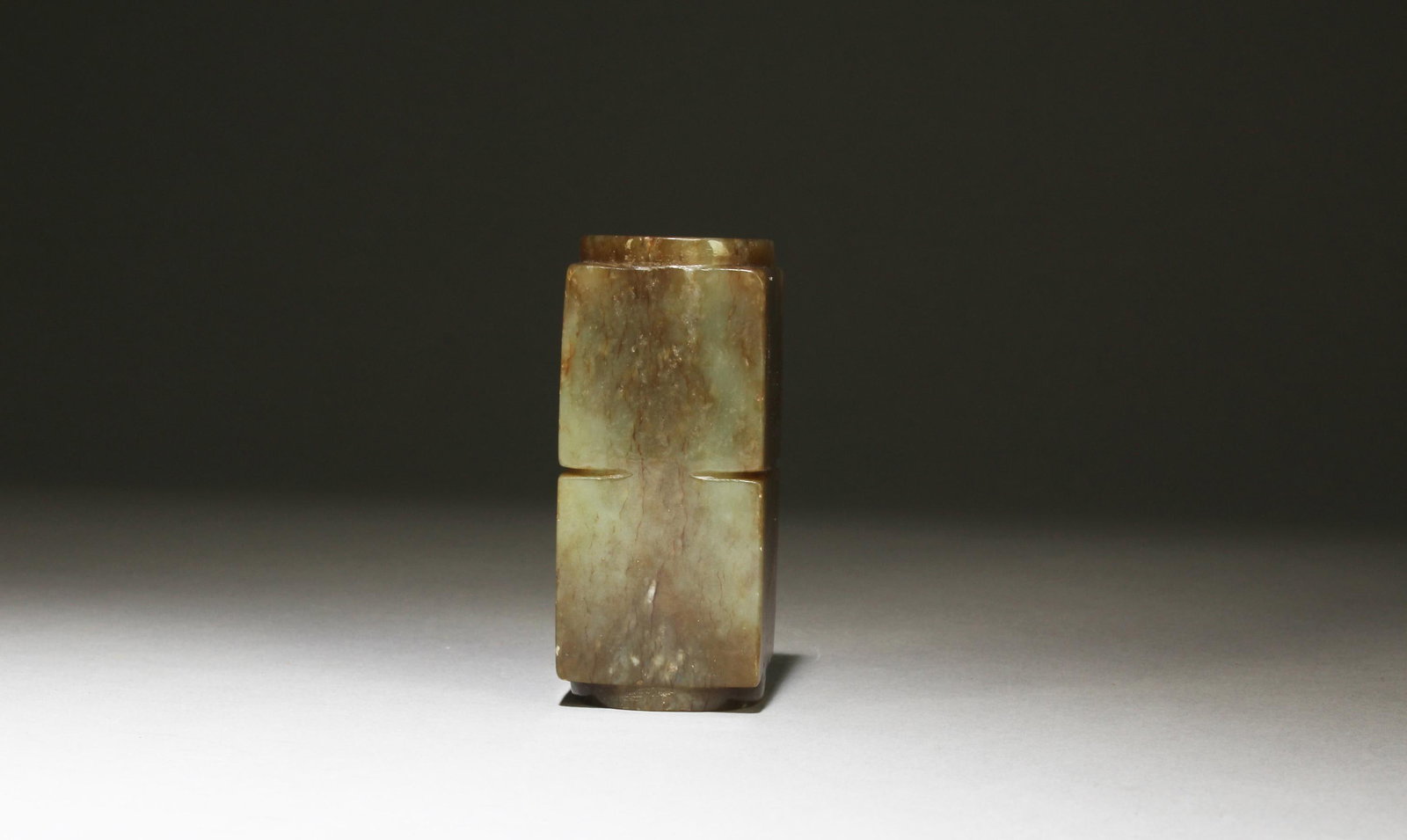 A Carved Jade 'Cong': A Carved Jade 'Cong'. Height: 2.95in. Diameter: 1.38in.