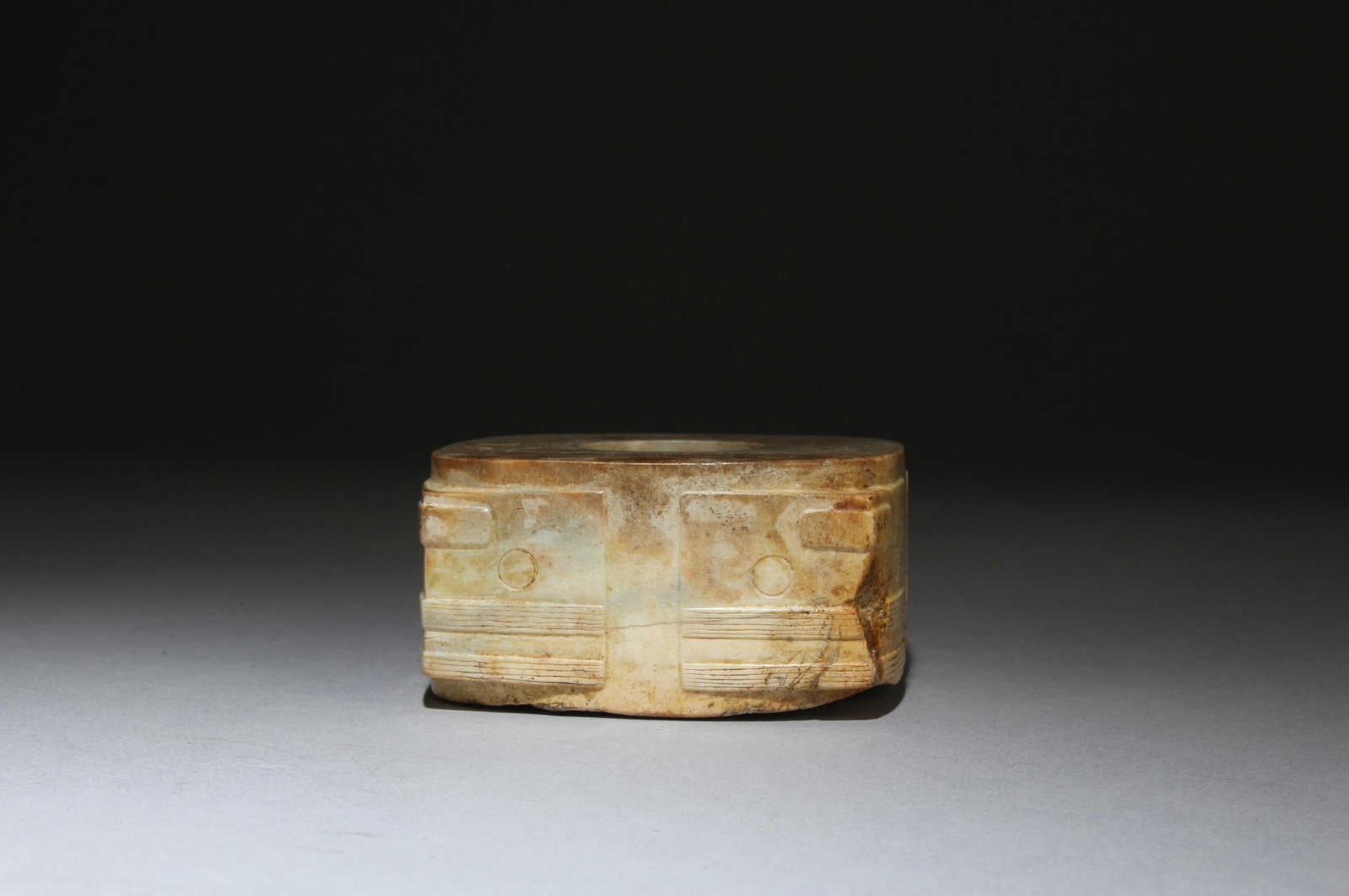 A Carved Jade 'Cong': A Carved Jade 'Cong'. Height: 1.42in. Diameter: 2.83in.