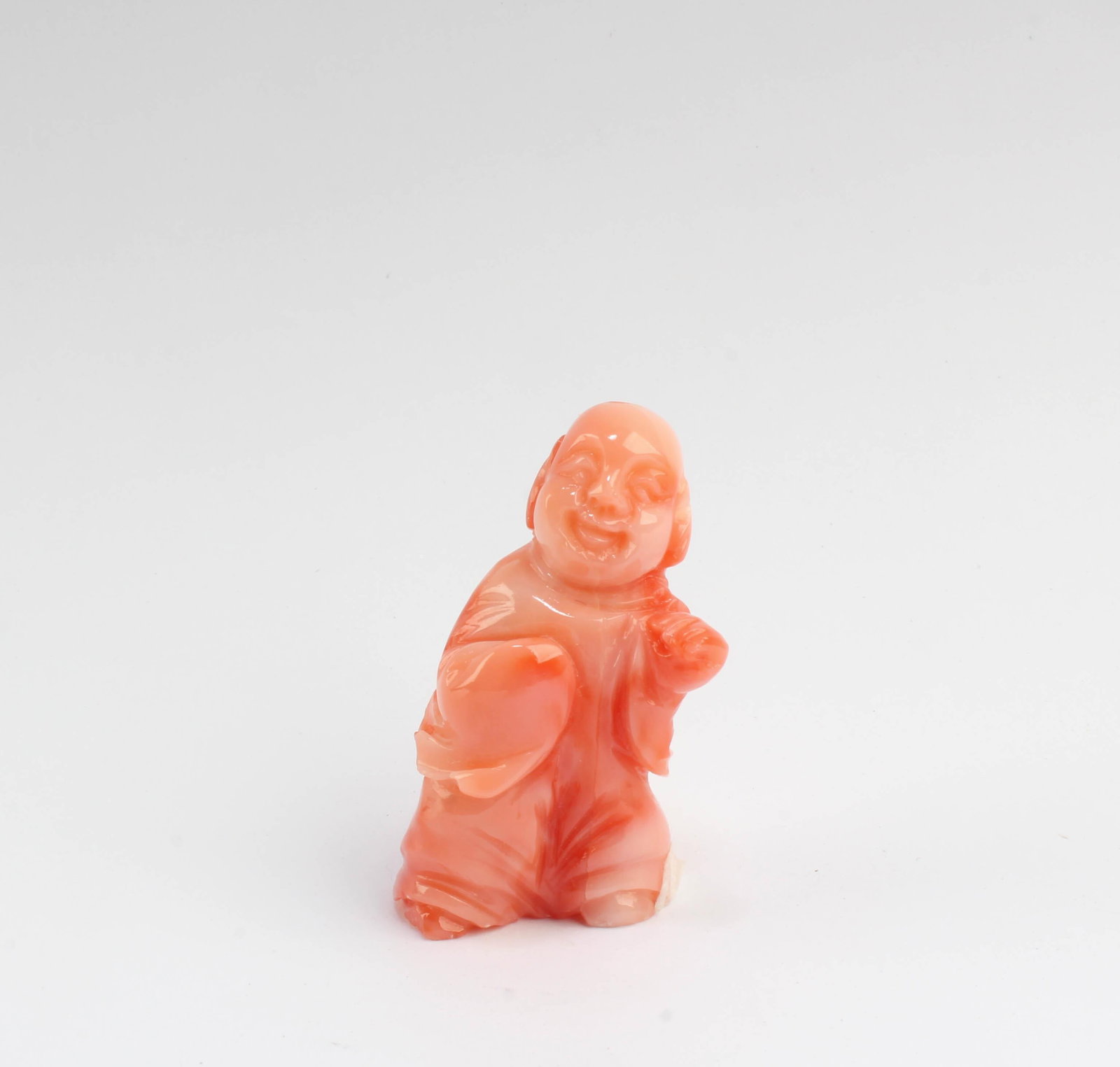 A Carved Coral Figurine: A Carved Coral Figurine. Height: 1.5"