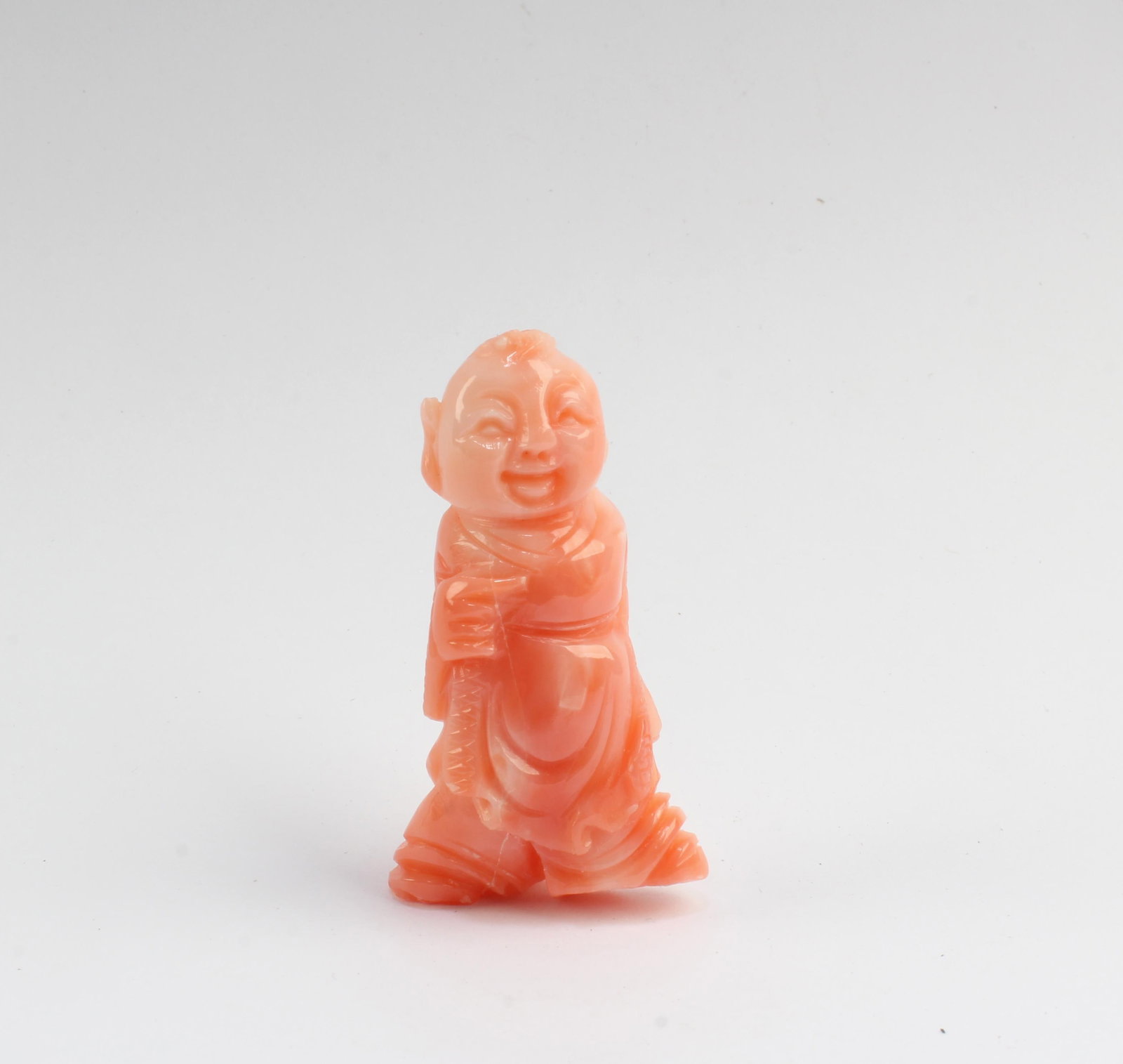 A Carved Coral Figurine: A Carved Coral Figurine. Height: 1.5"