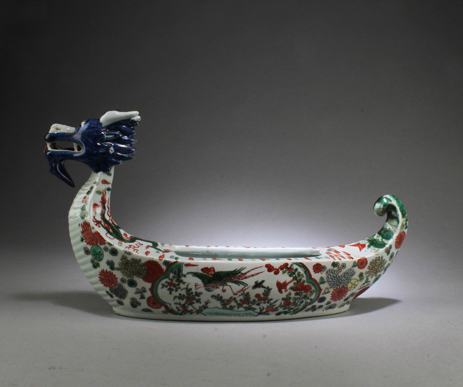 A Porcelain Boat Shaped Container: A Porcelain Boat Shaped Container. 'WanLi' mark at base. Height: 8.75" Length: 16.5" Width: 14"