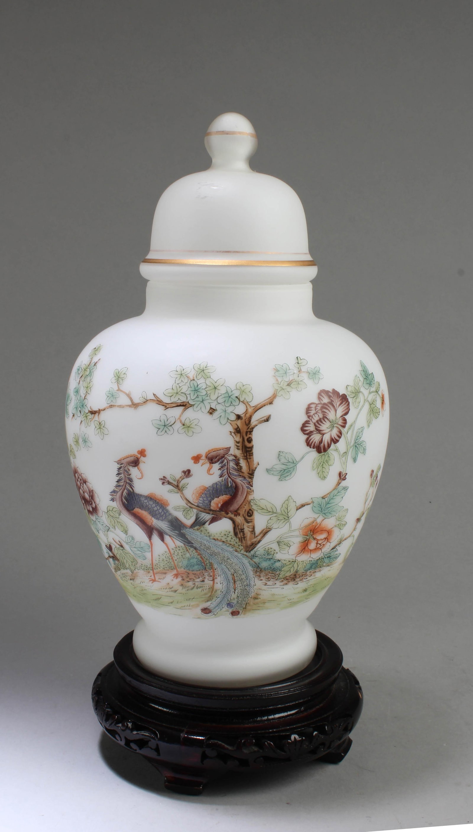 A Glass Jar with Lid: A Glass Jar with Lid. Comes fitted with a wooden stand. Height: 10.5"