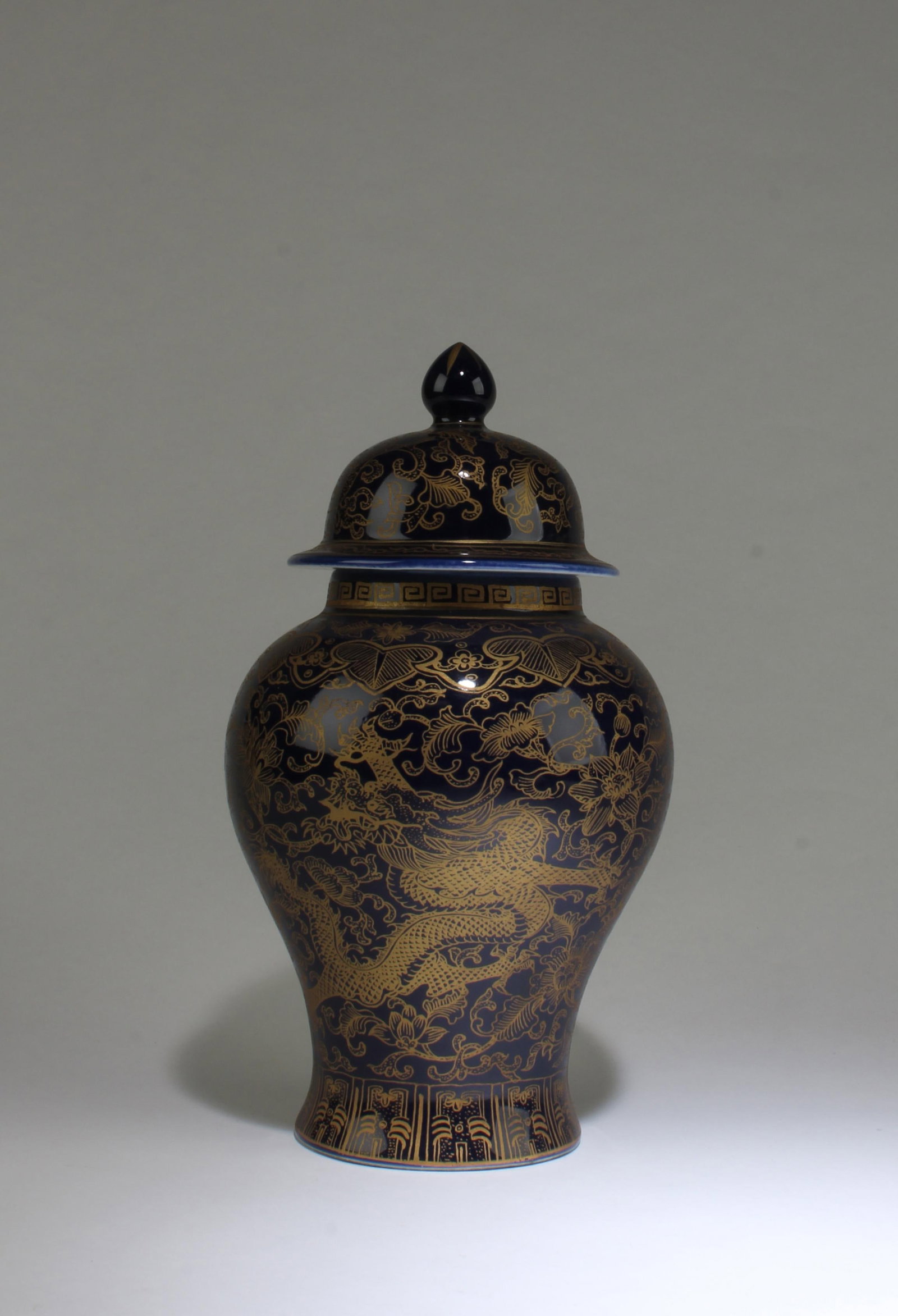 A Porcelain Jar: A Porcelain Jar with lid, the body with gold splash. 'QianLong' mark. Height: 9.5" Diameter: 5.5"